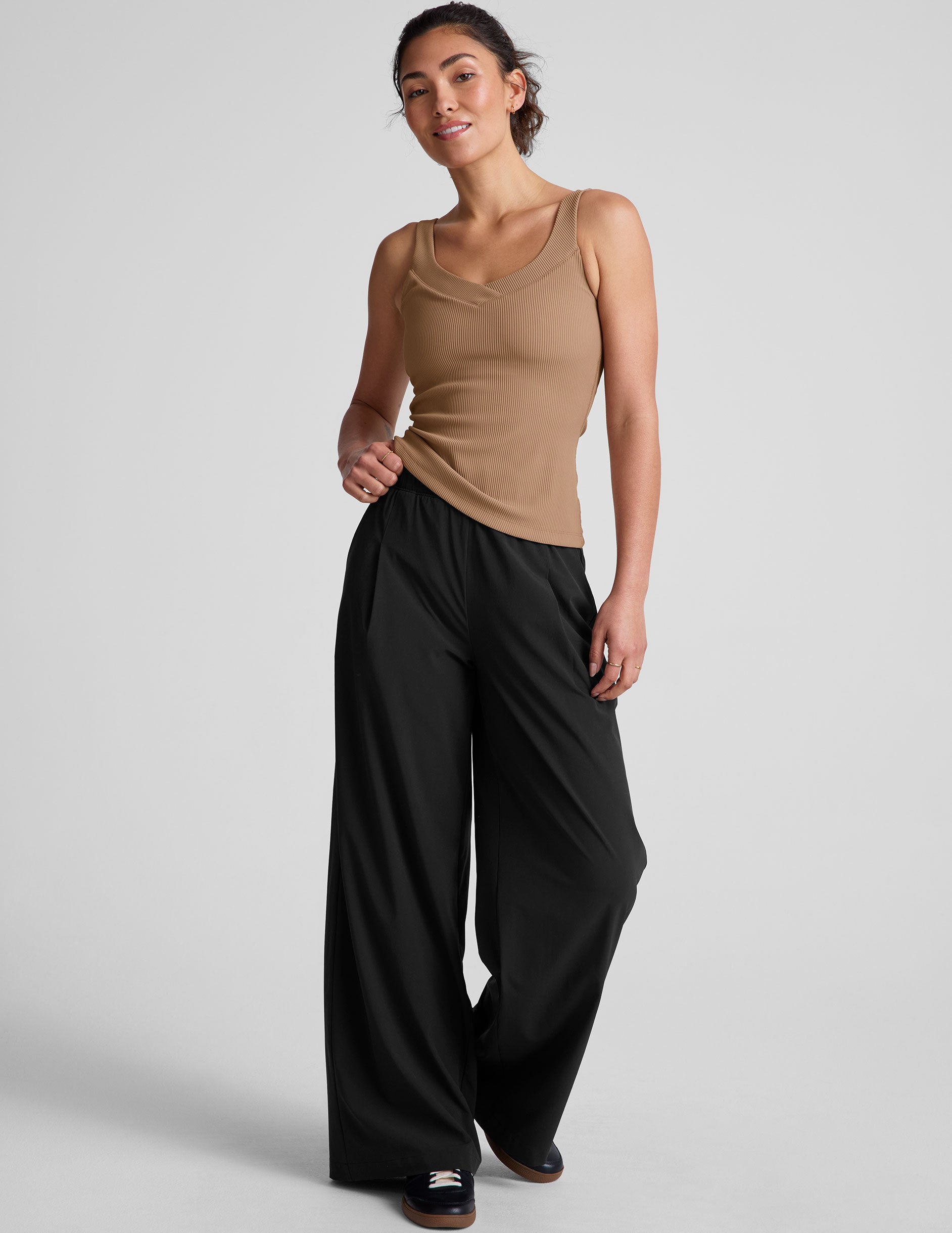 brown classic length tank top with a soft V neckline front and back, overlapping front neckline detail, and a performance lining shelf bra. Tank hits at a high hip length.