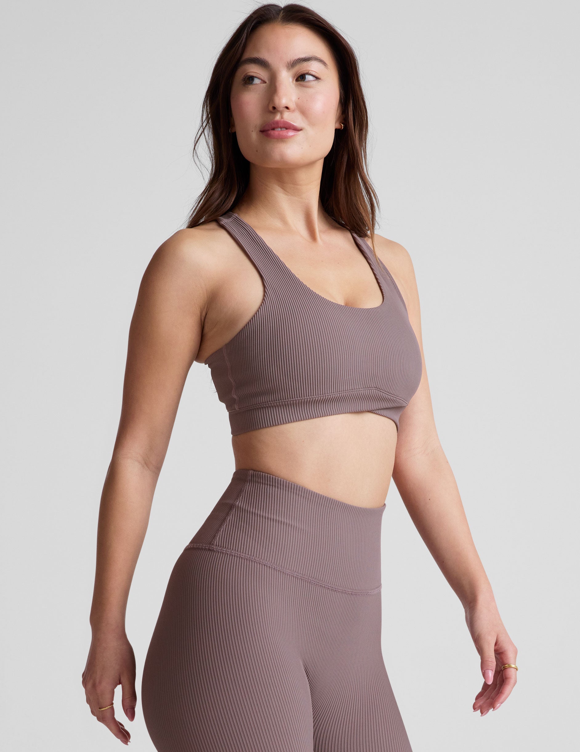 brown medium support racerback bra with a scoop neckline, overlapping hemband detail, is lined with performance lining and powermesh in between, and has removable bra pads.