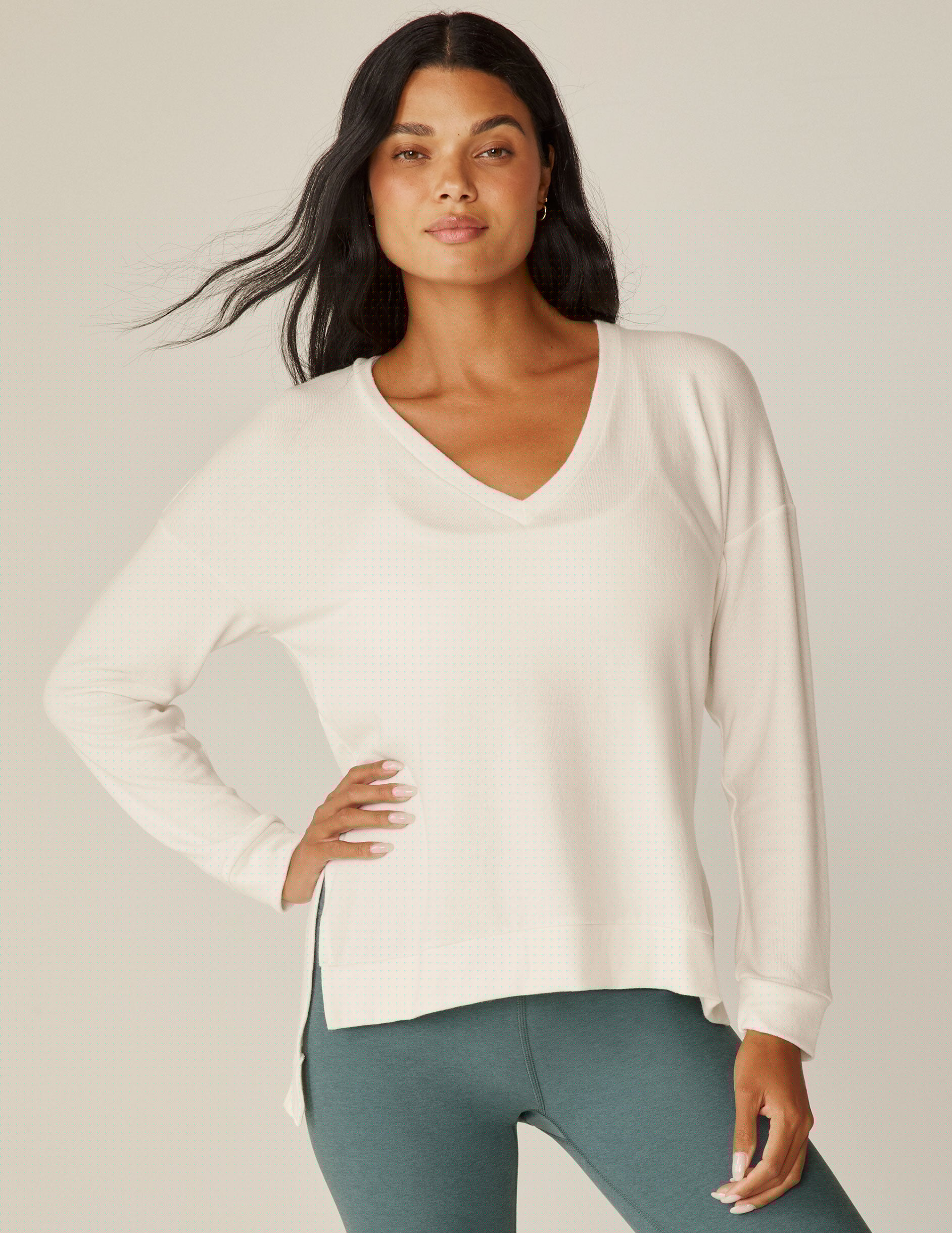 white v-neck pullover sweater with a high low hem.