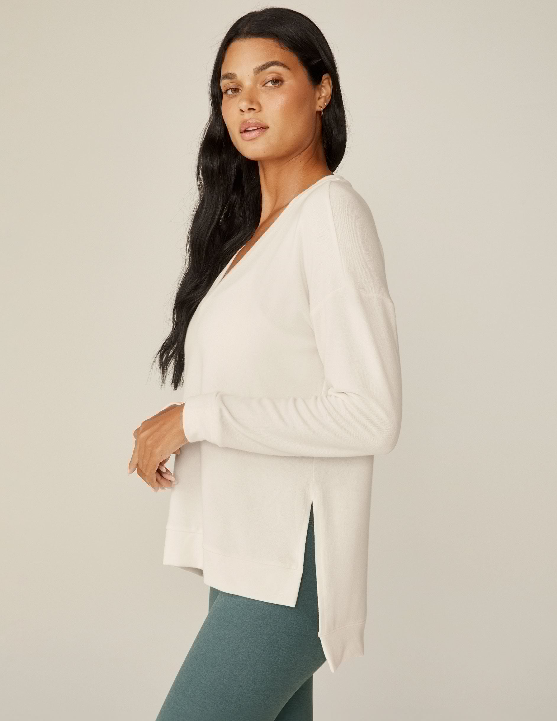 white v-neck pullover sweater with a high low hem.