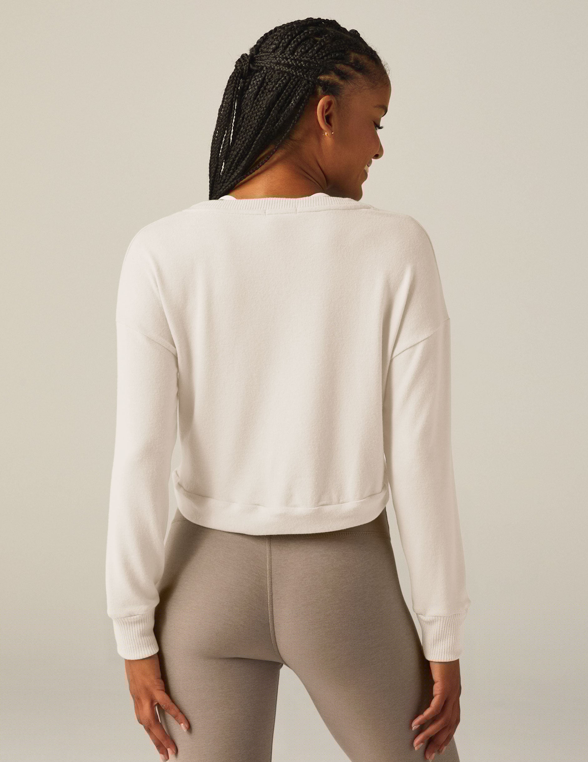 white scoop neck cropped pullover with a front tie detail.