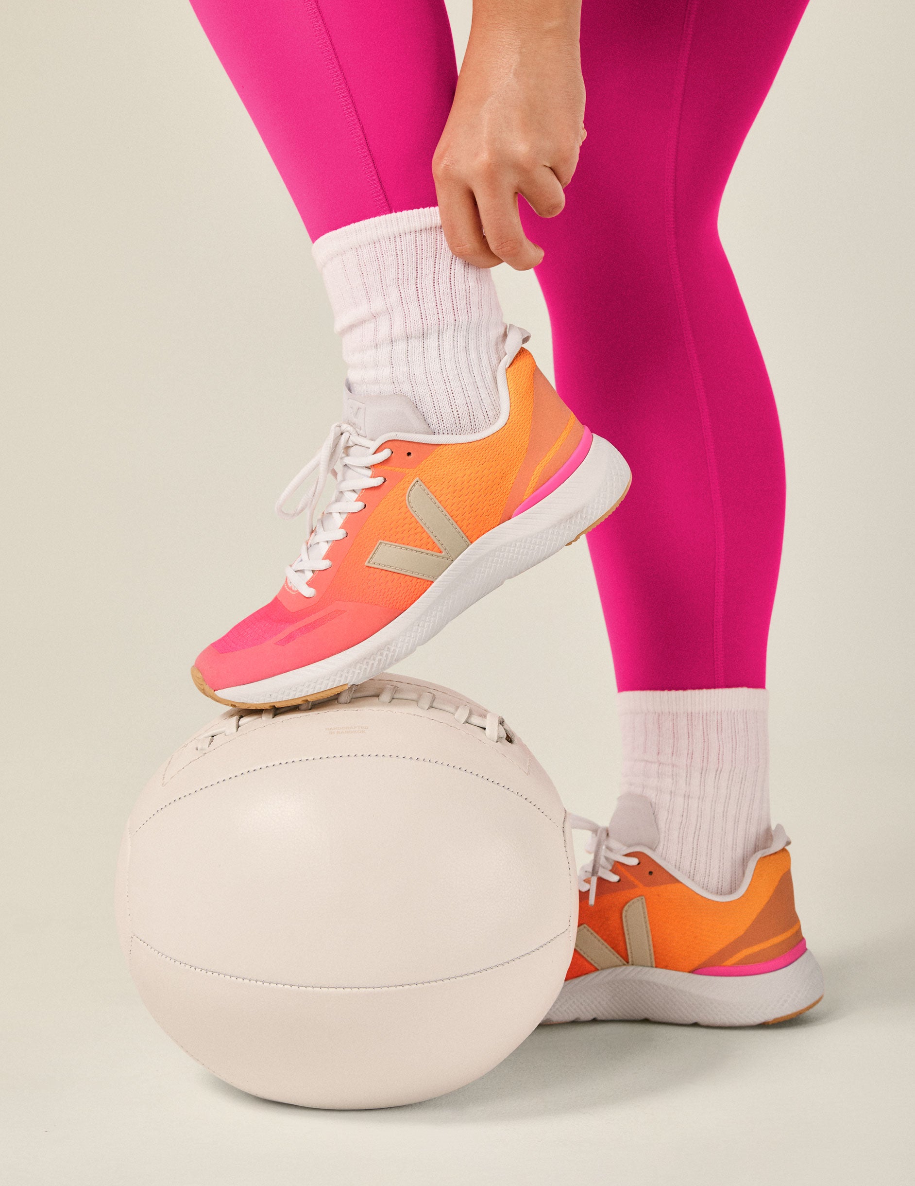 orange and pink lace up sneakers from Veja.
