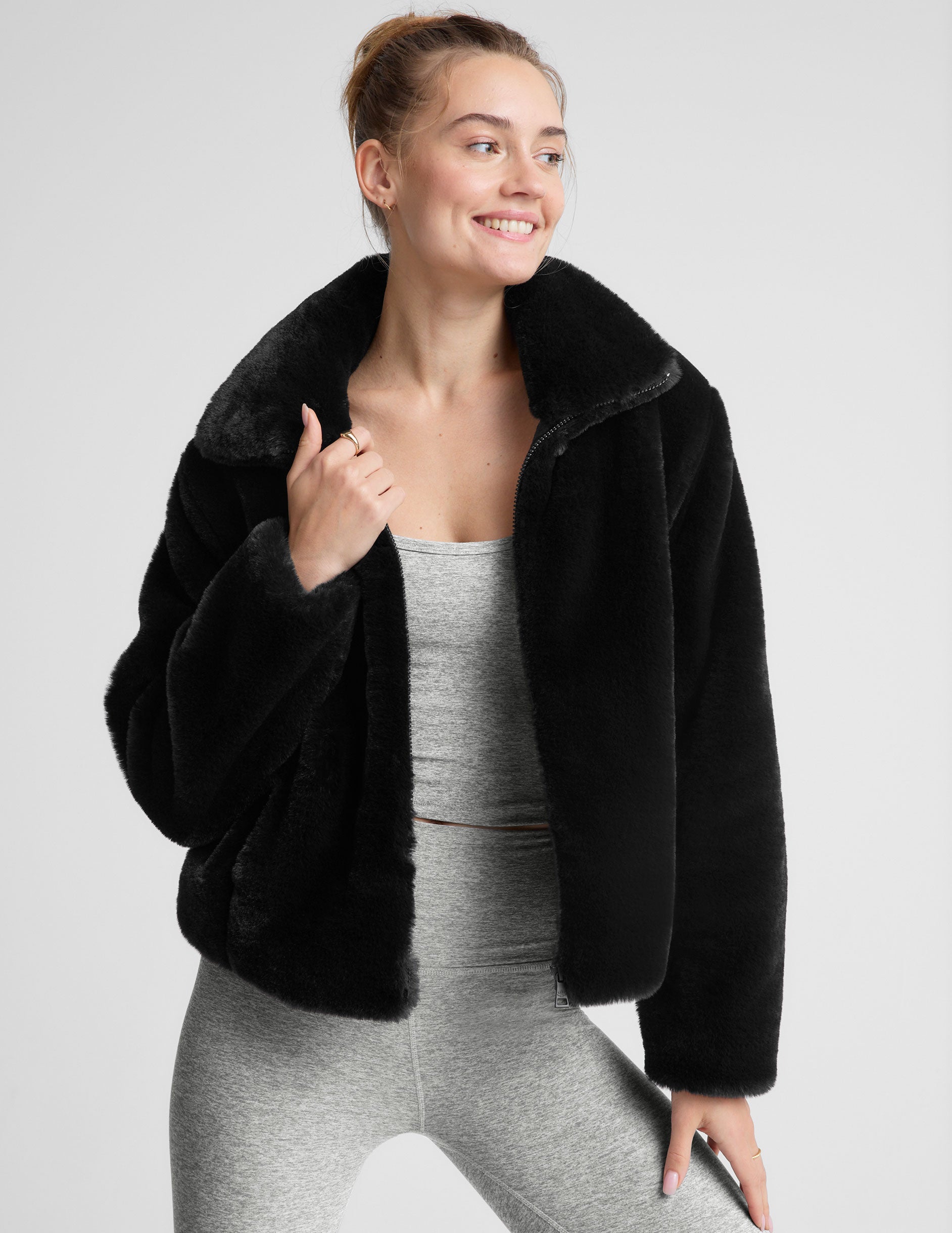 black faux fur zip-up collared jacket.
