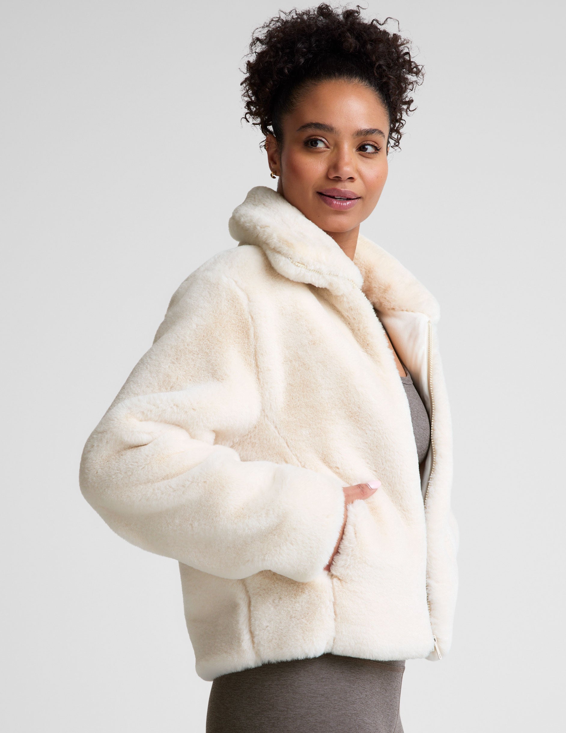 white faux fur zip-up collared jacket.