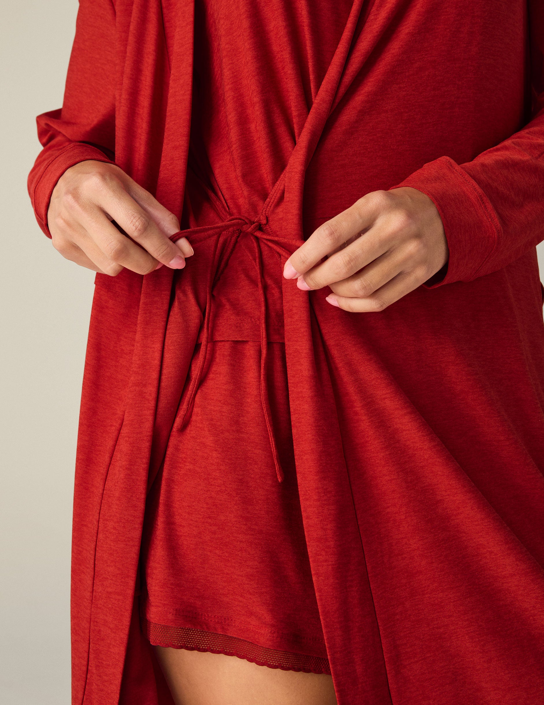 red sleep robe with a tie at the waist and side pockets.