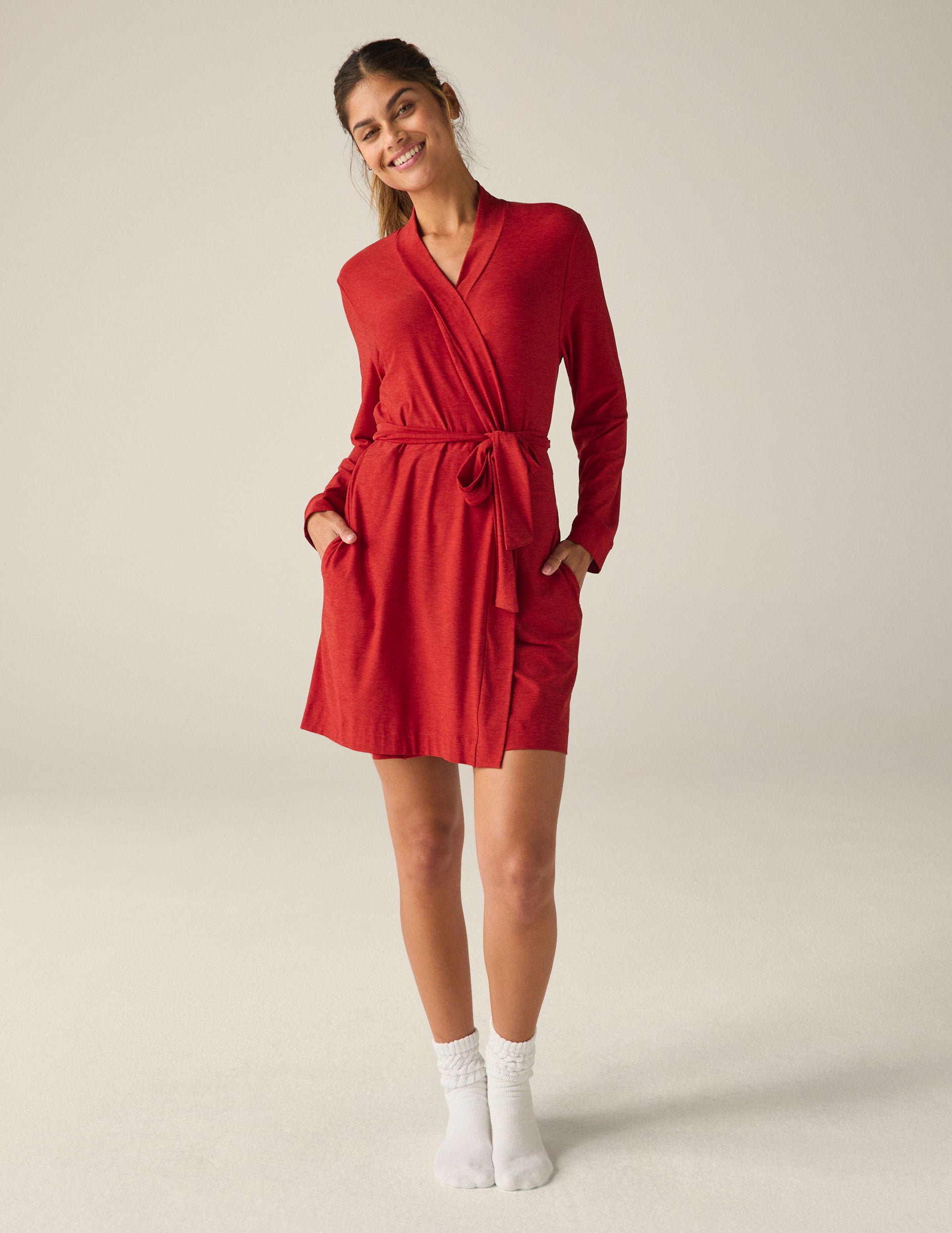 red sleep robe with a tie at the waist and side pockets.