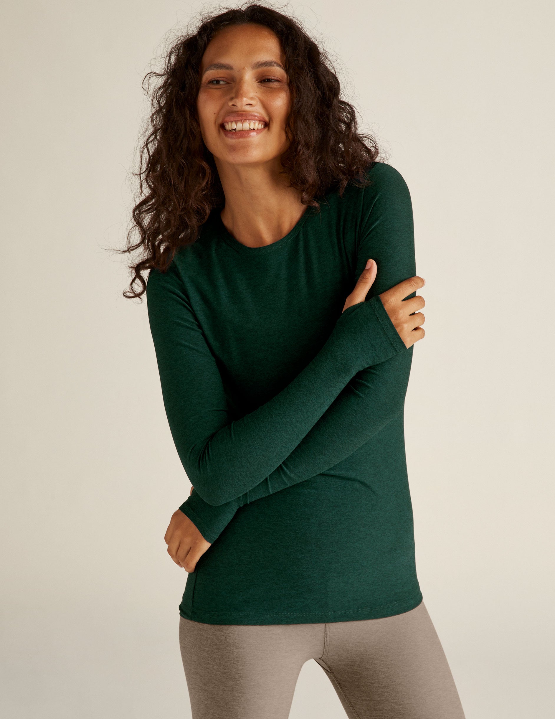 green scoop neck long sleeve top with thumb holes.