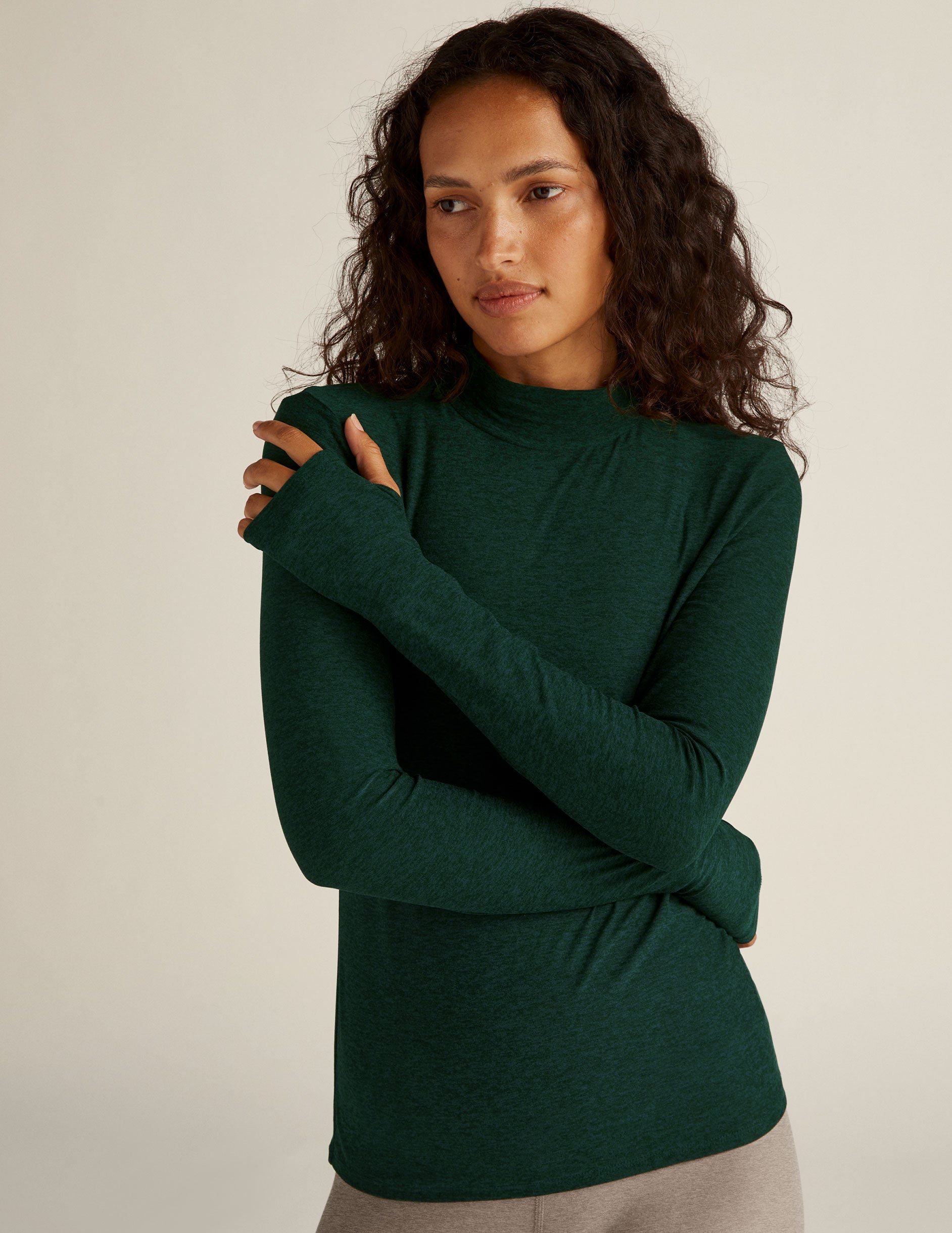 green mock neck long sleeve top with thumb holes.