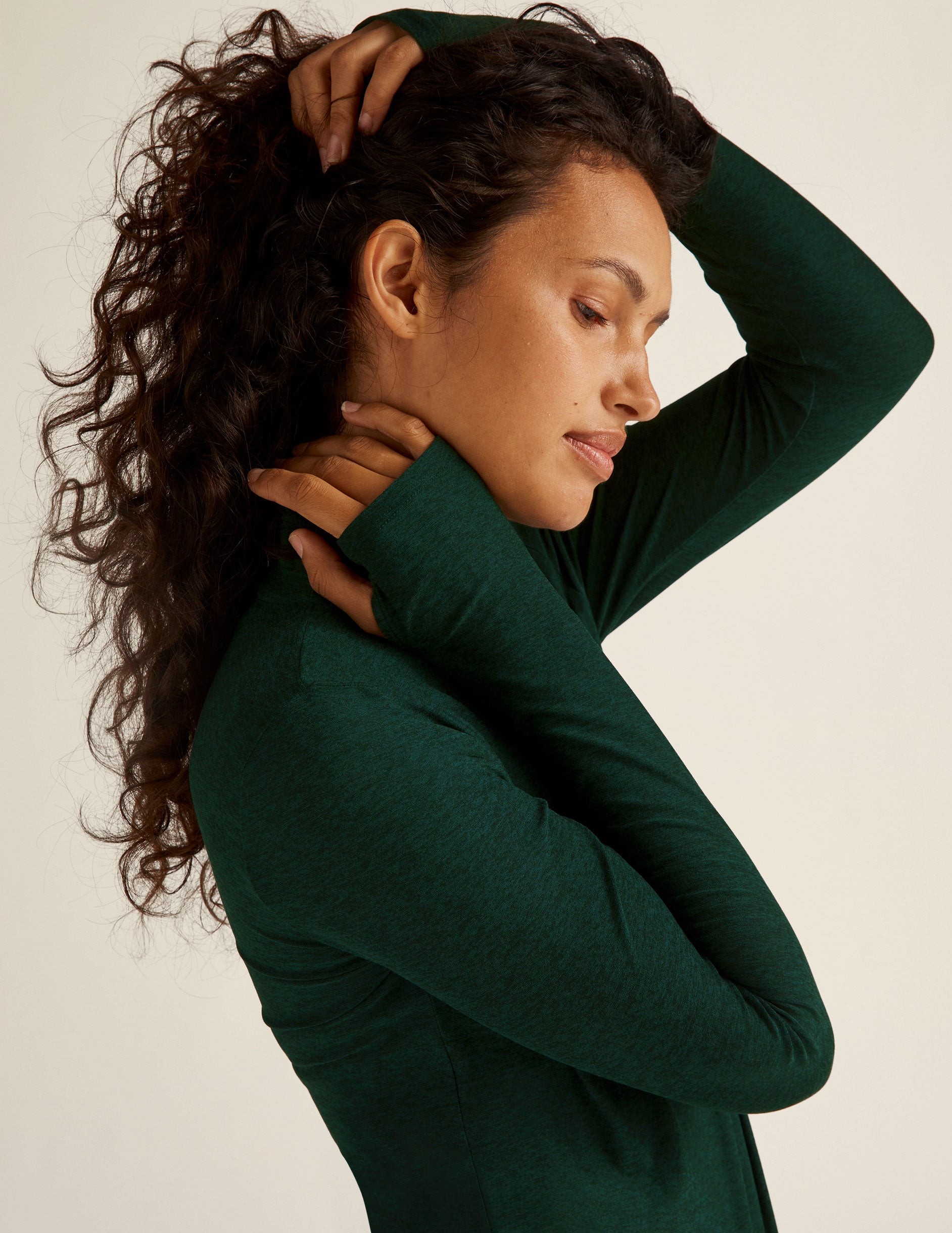 green mock neck long sleeve top with thumb holes.