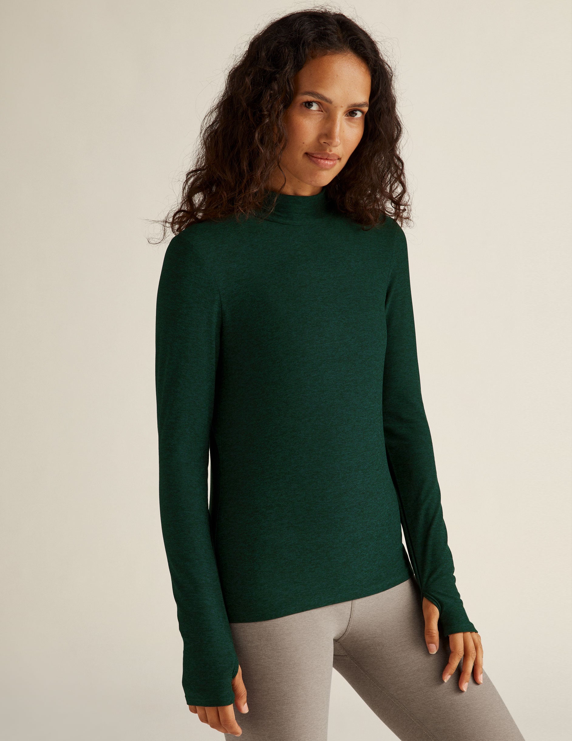 green mock neck long sleeve top with thumb holes.