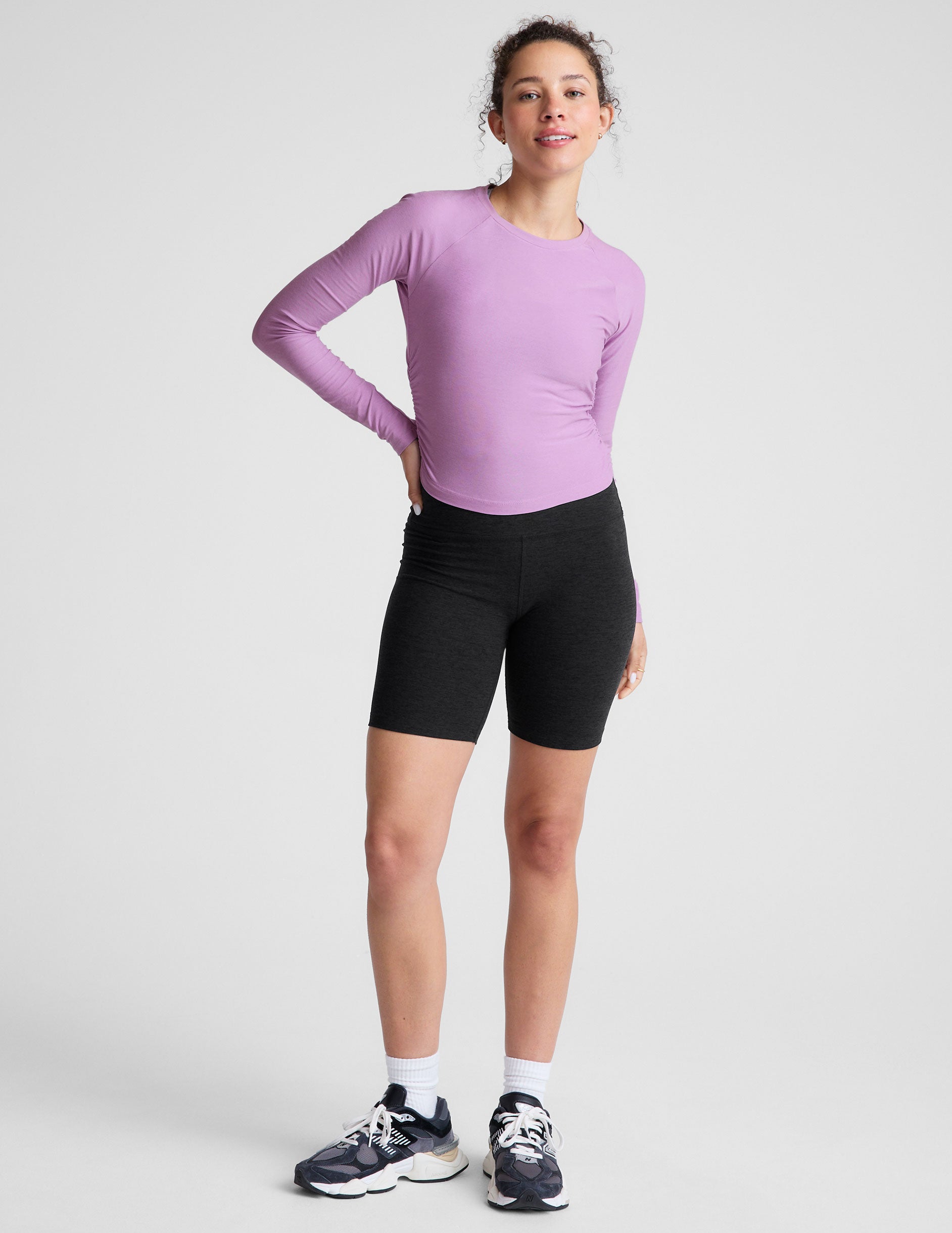 purple scoop neck long sleeve top with shirring on the sides.