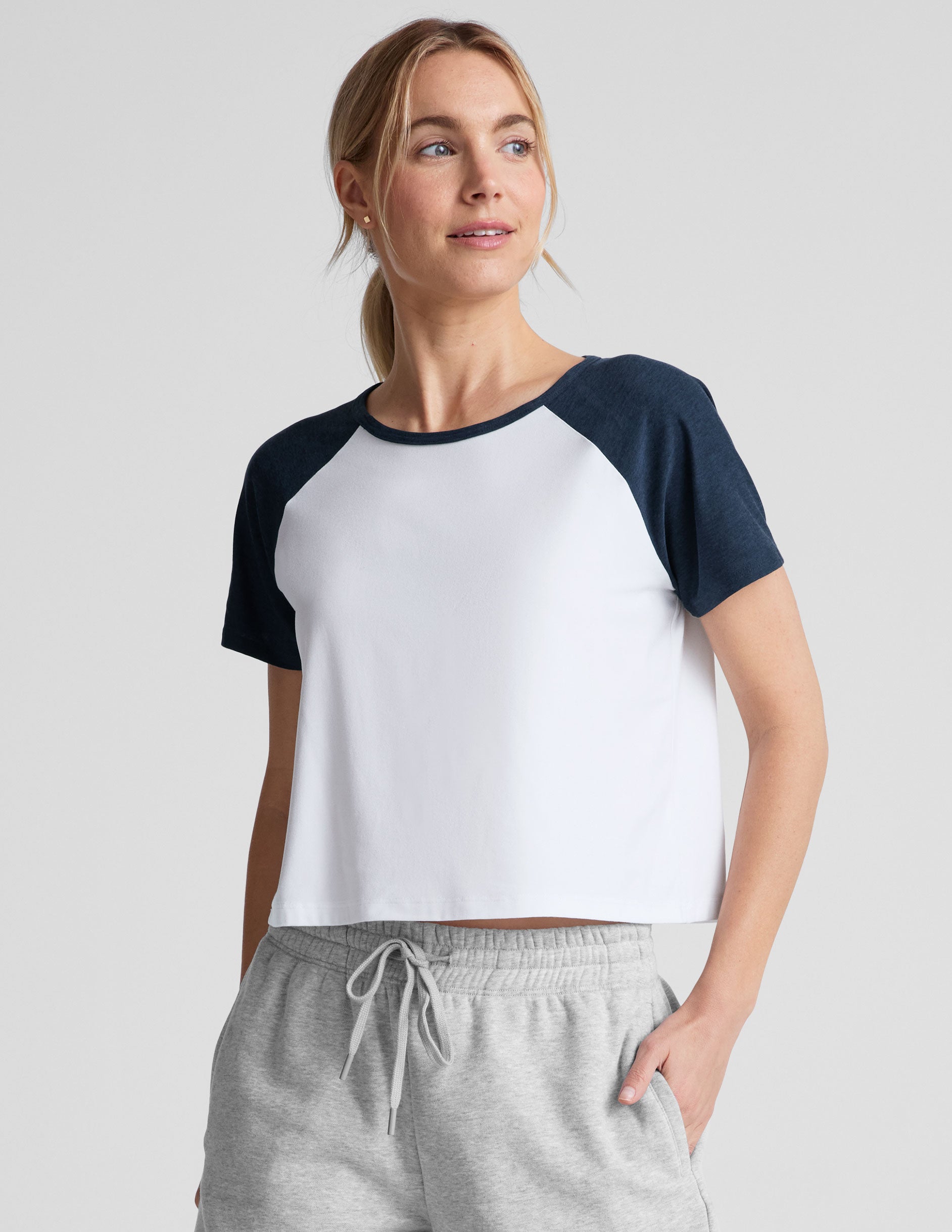 white relaxed fit, waist length t-shirt with colorblock raglan sleeve and neck binding.
