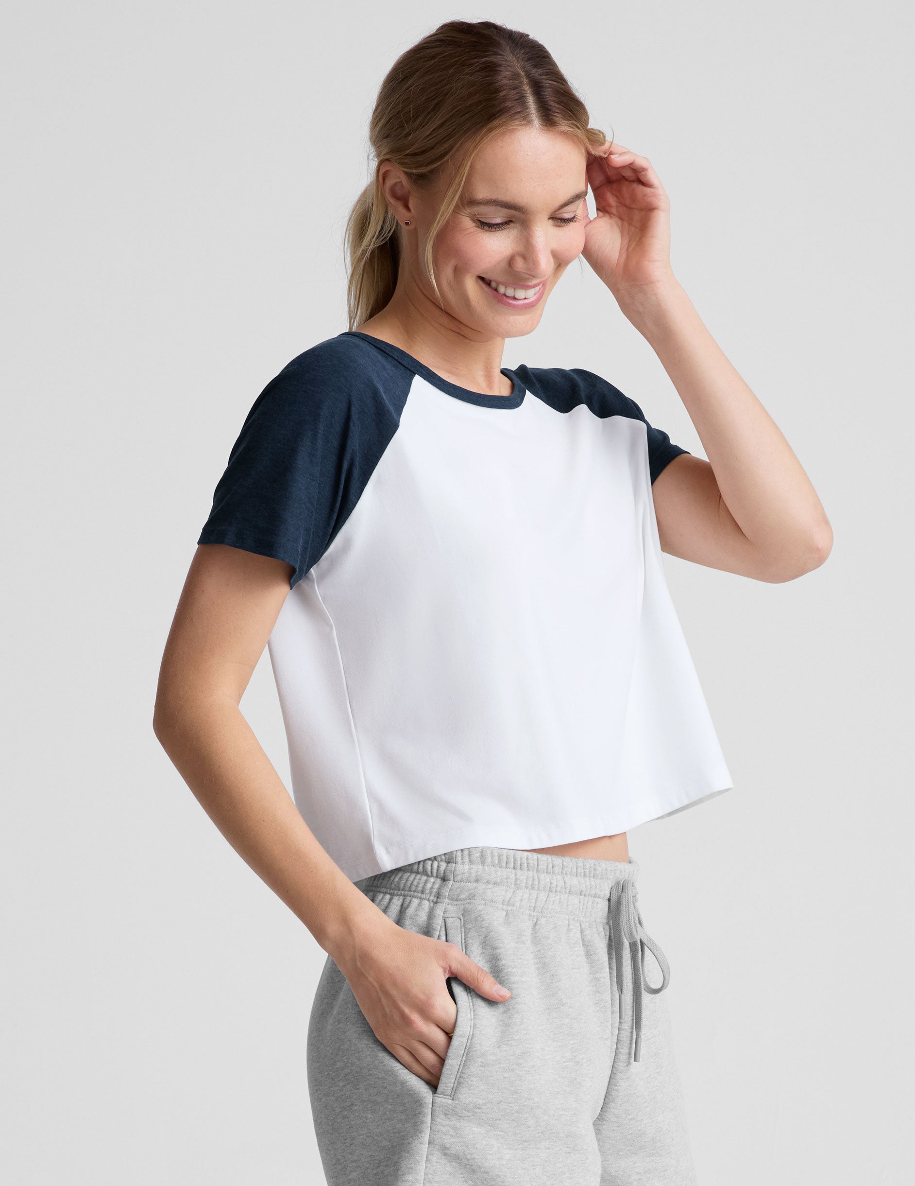 white relaxed fit, waist length t-shirt with colorblock raglan sleeve and neck binding.