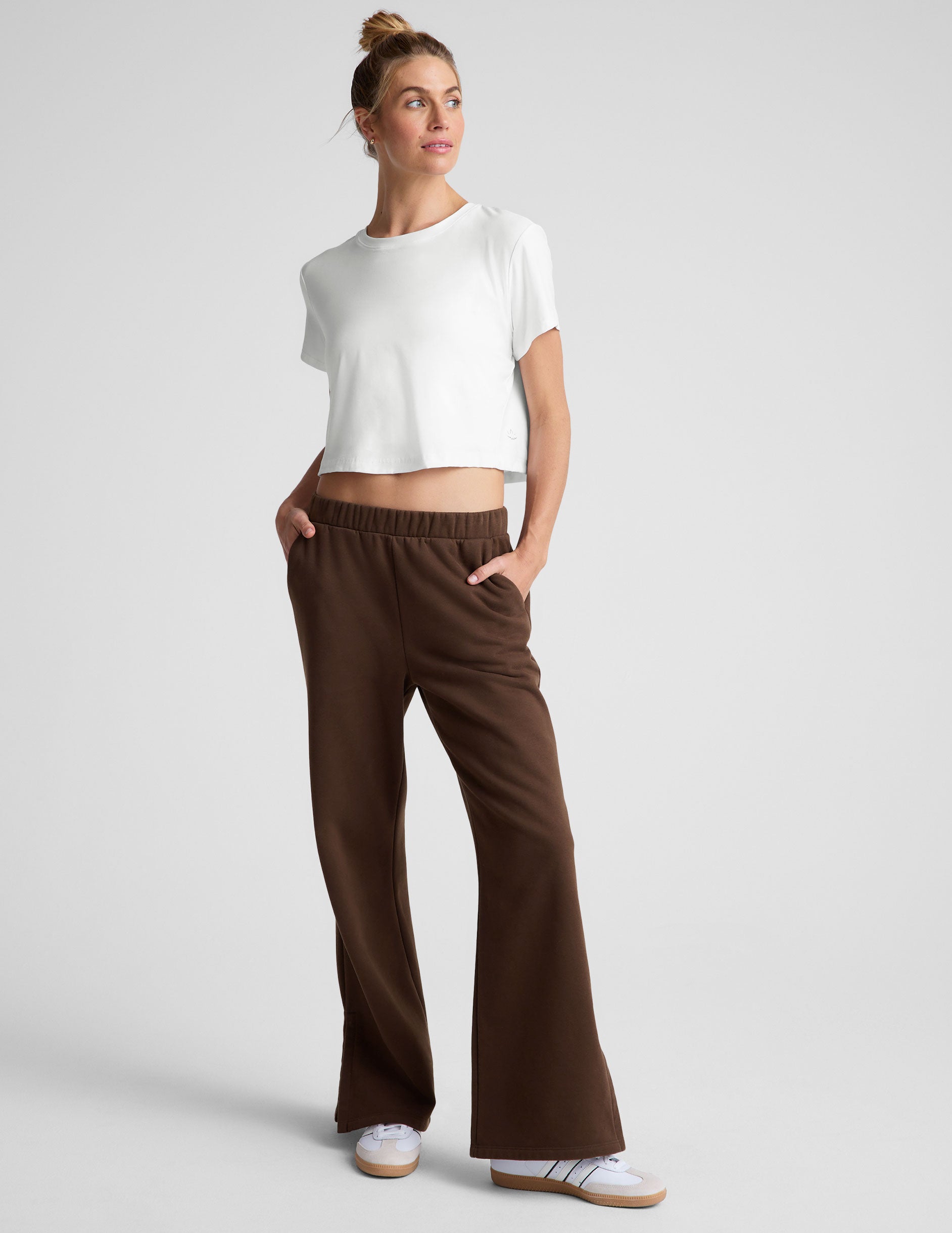 brown mid-rise, wide leg fleece sweatpants with side slits at the ankle and pockets.