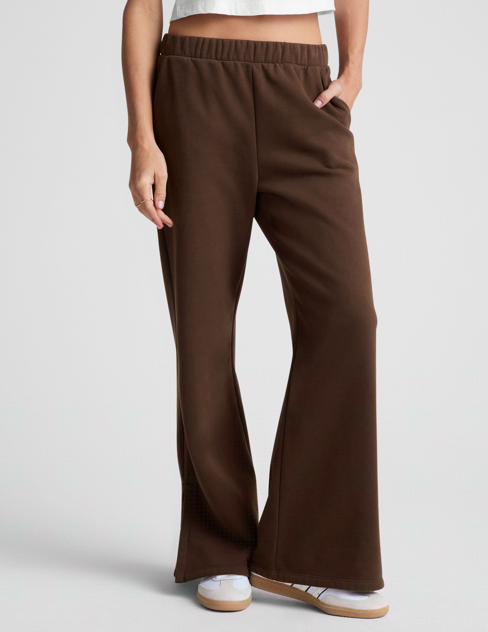 brown mid-rise, wide leg fleece sweatpants with side slits at the ankle and pockets.