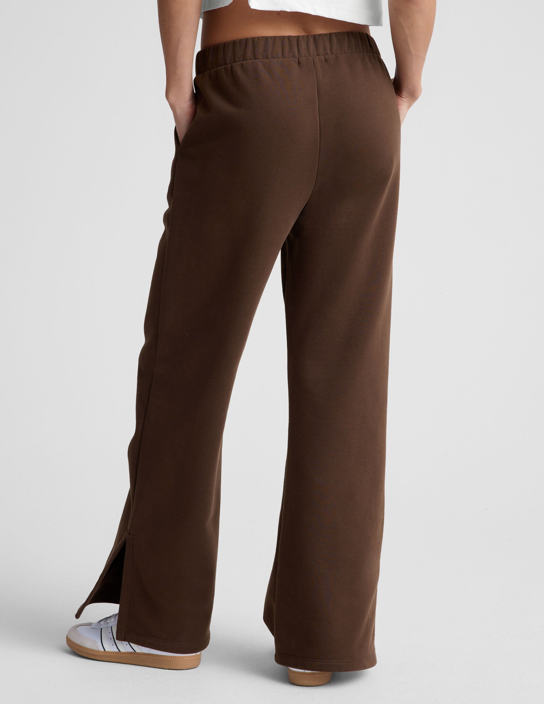 brown mid-rise, wide leg fleece sweatpants with side slits at the ankle and pockets.