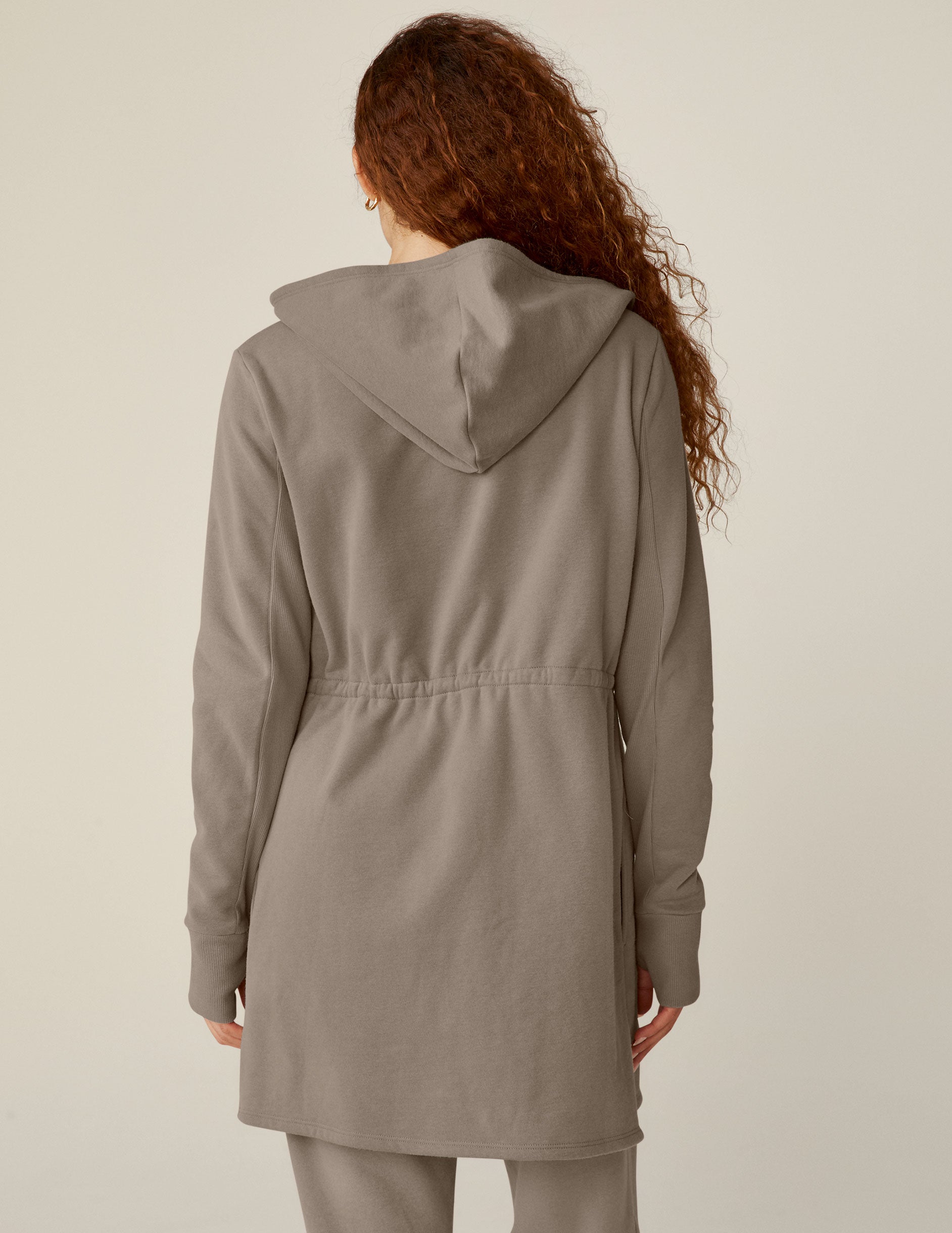 brown hooded jacket with a cinched waistband.