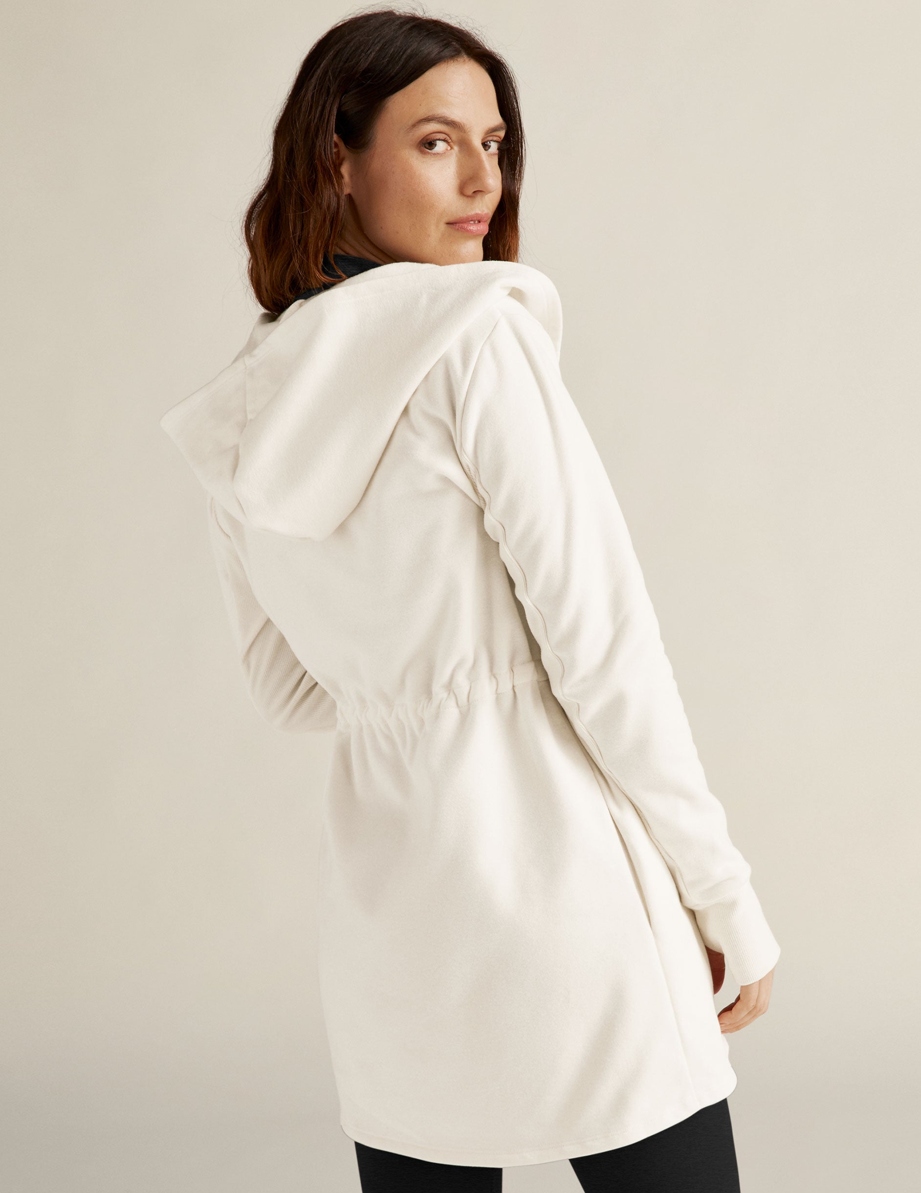 white jacket with drawstring at waist.