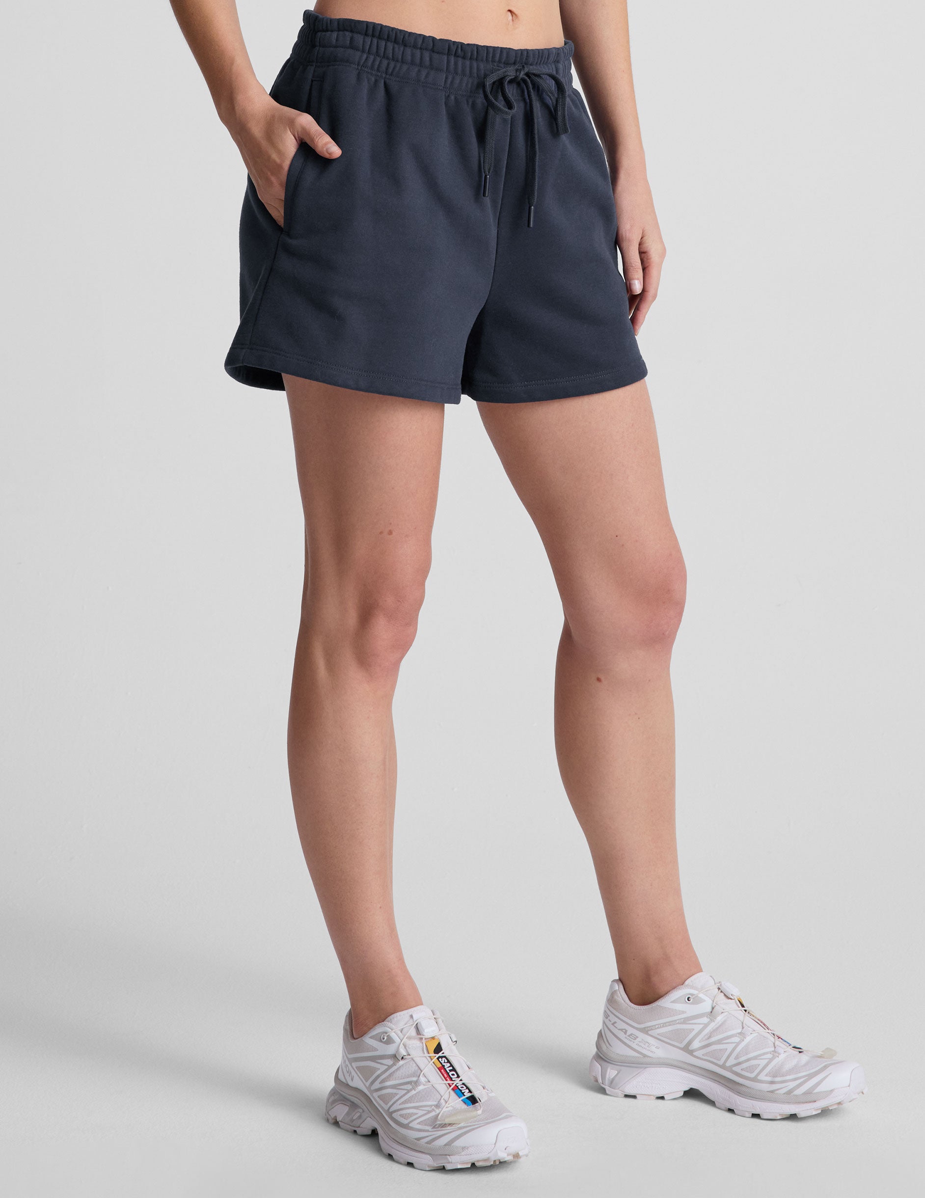 blue sweat shorts with pockets and a drawstring at waistband.