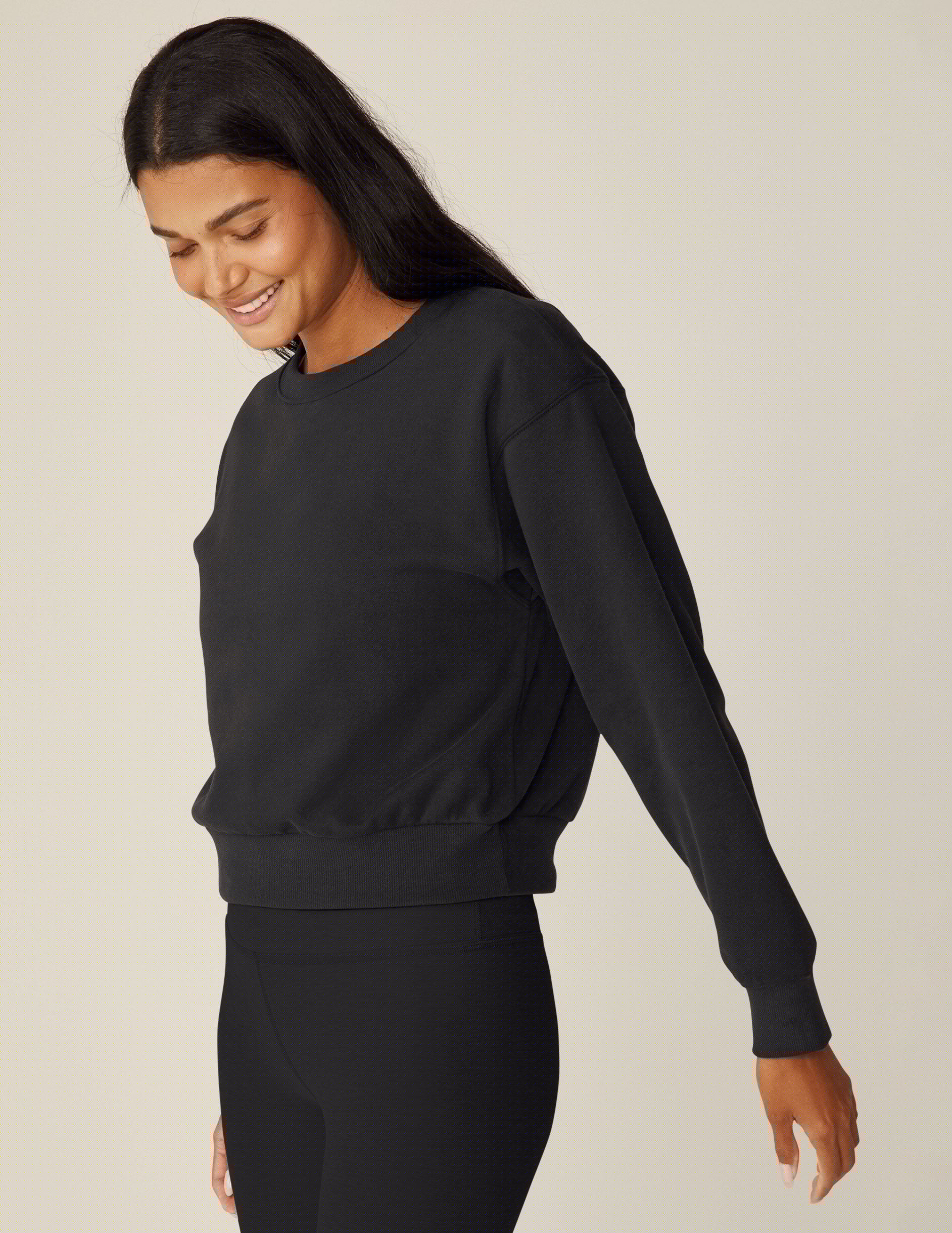 black loose-fitting classic length crew neck sweatshirt.