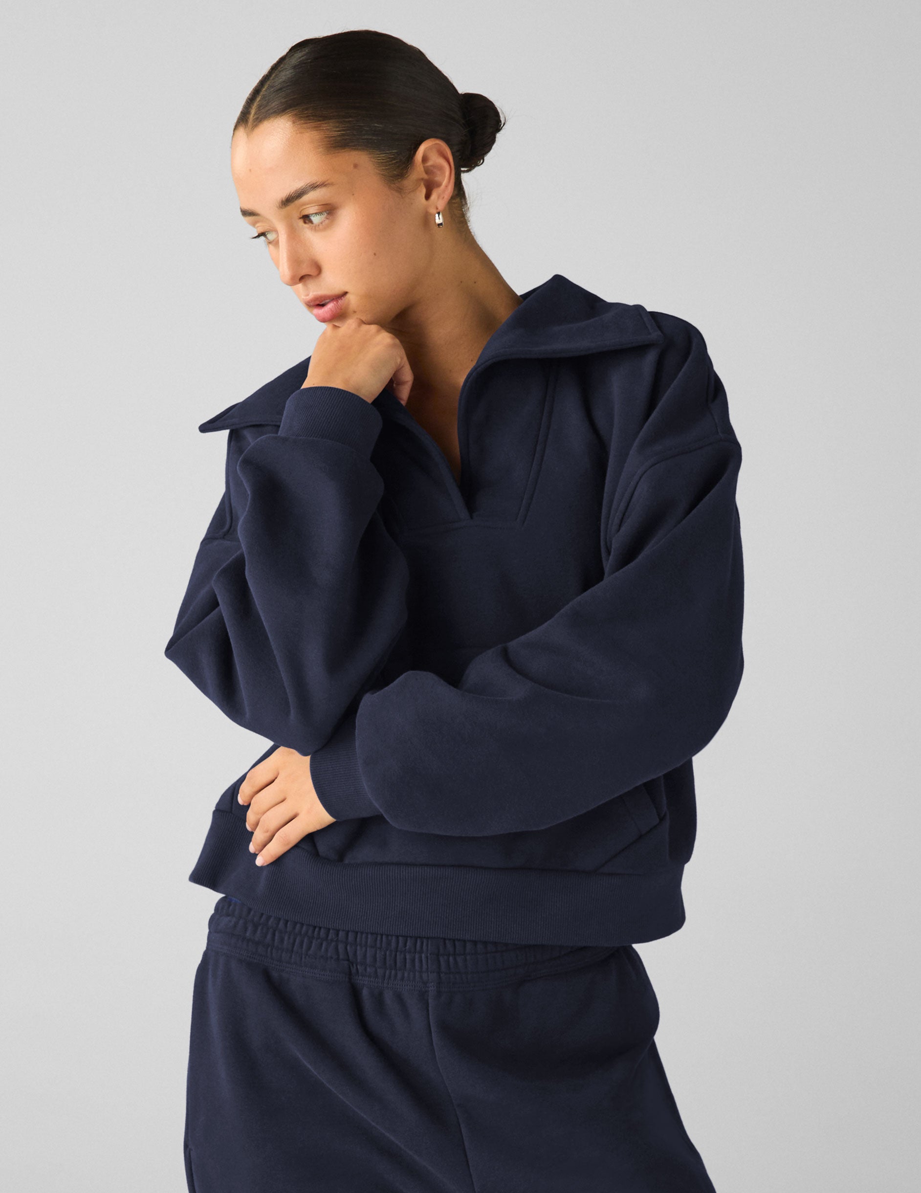 blue pullover sweater with a collar and kangaroo pocket.