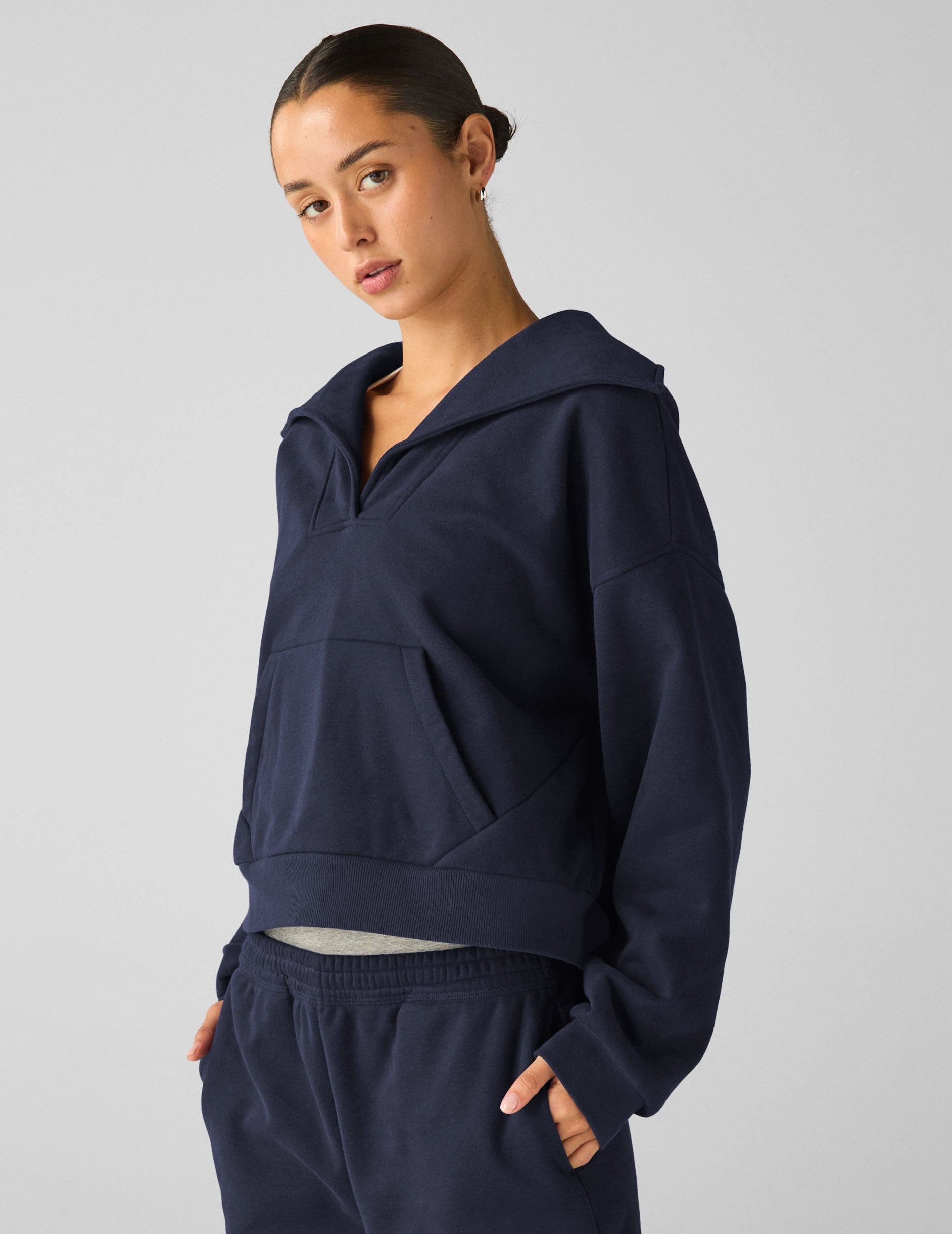 blue pullover sweater with a collar and kangaroo pocket.