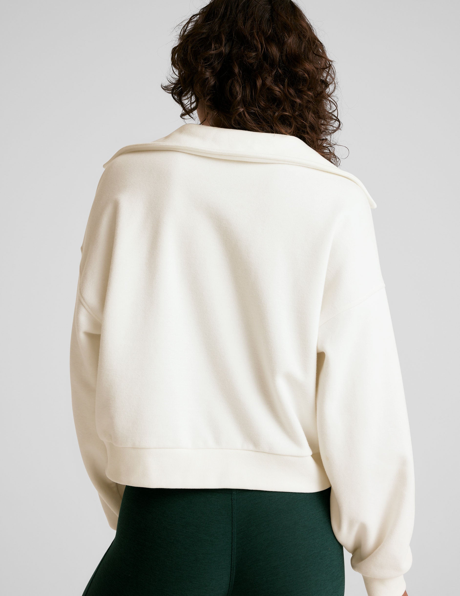 white pullover sweatshirt with a collar and kangaroo pocket.