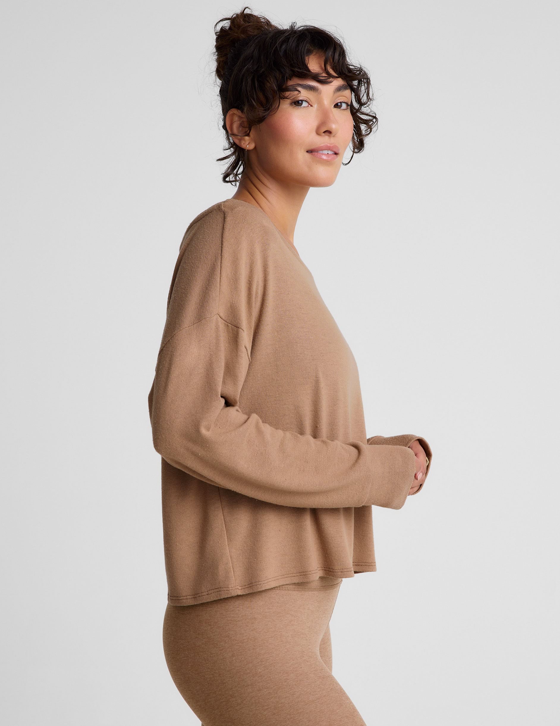 brown classic length long sleeve sweater with a wide off-the-shoulder neckline.