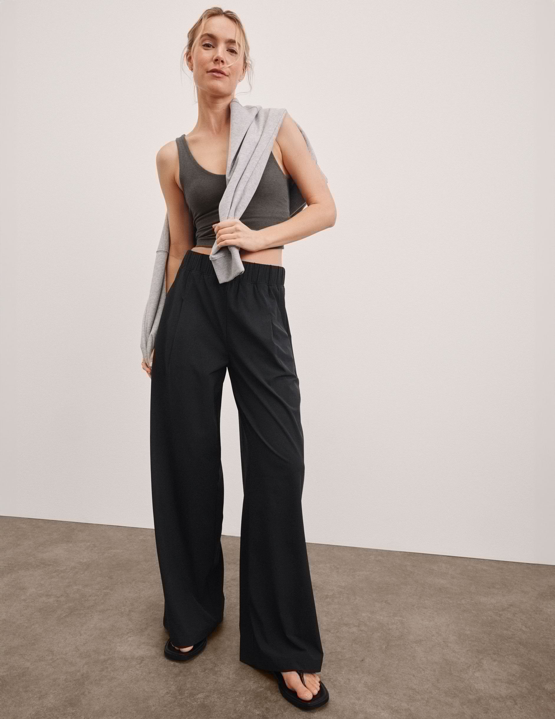 black mid rise relaxed fit wide leg pant with front side seam pockets and back pockets.