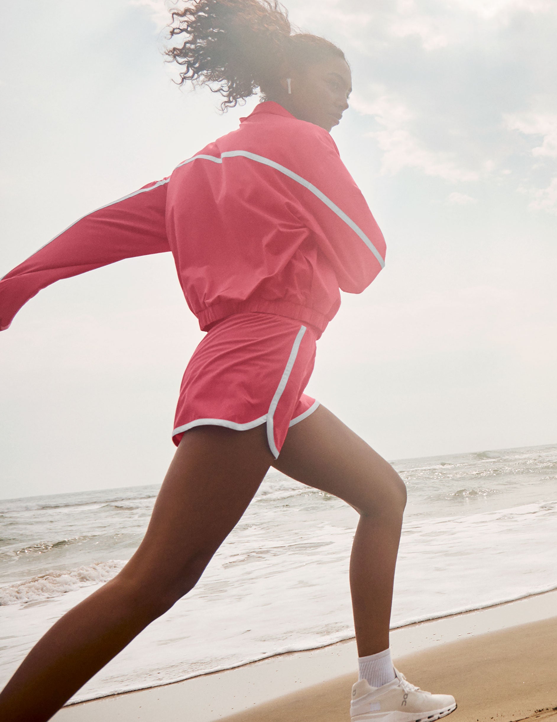 pink zip-up jacket with white trim and pockets.