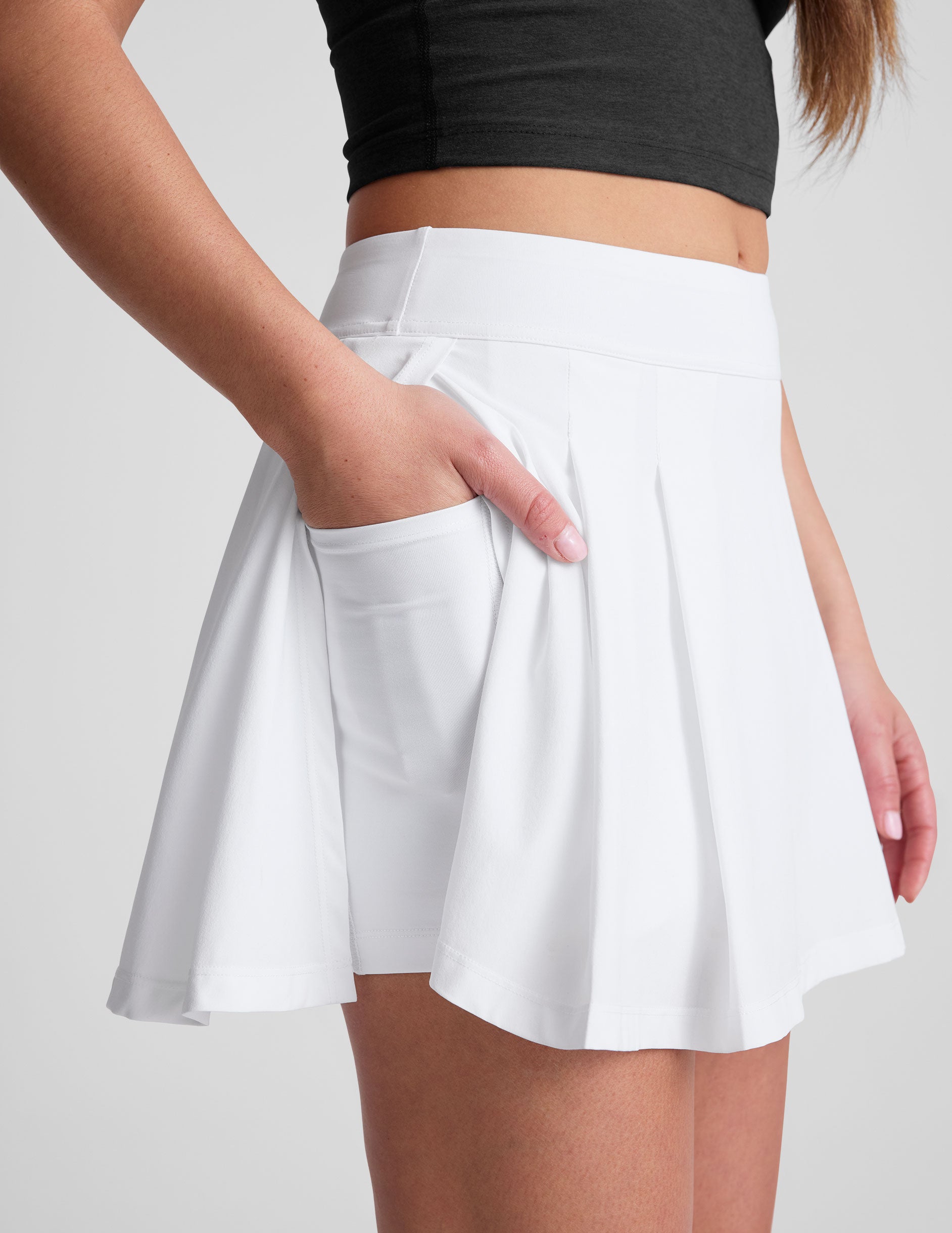white mini pleated skirt with interior shorts with pockets.