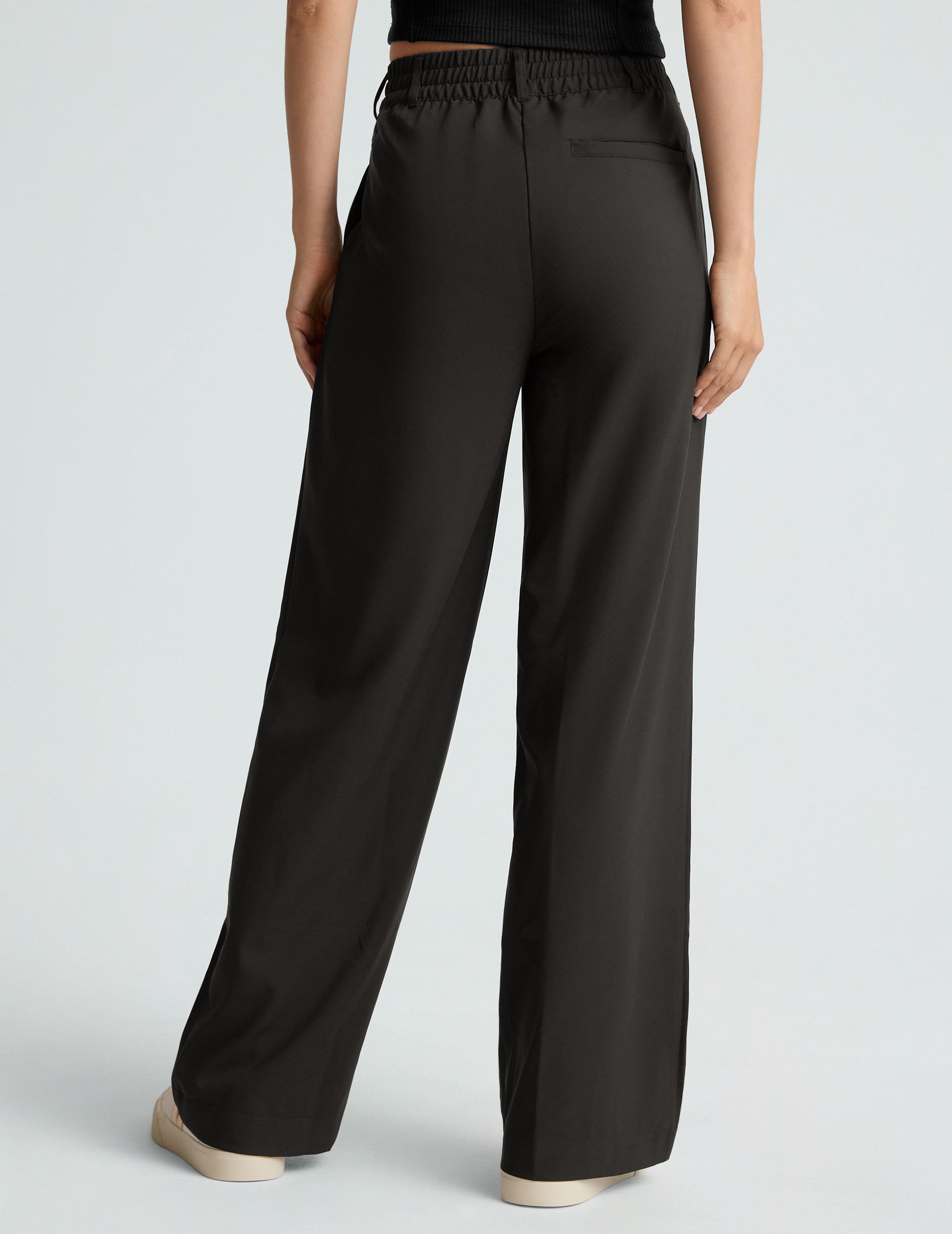 black mid rise jetstretch woven pants with cargo style pockets.