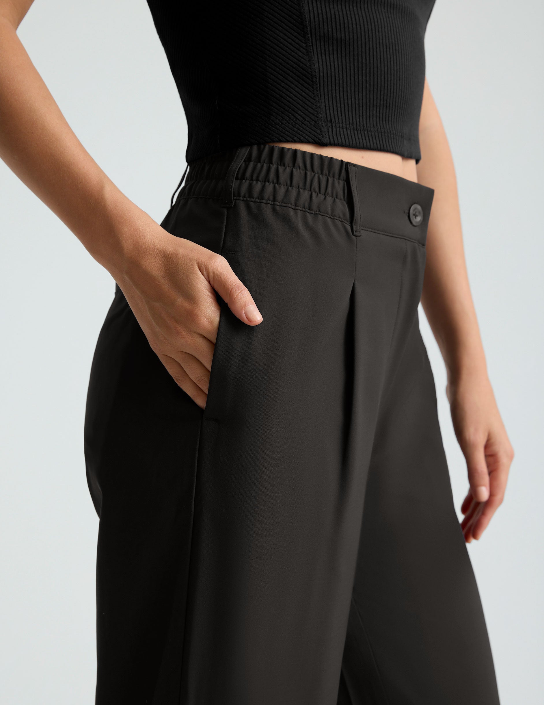 black mid rise jetstretch woven pants with cargo style pockets.