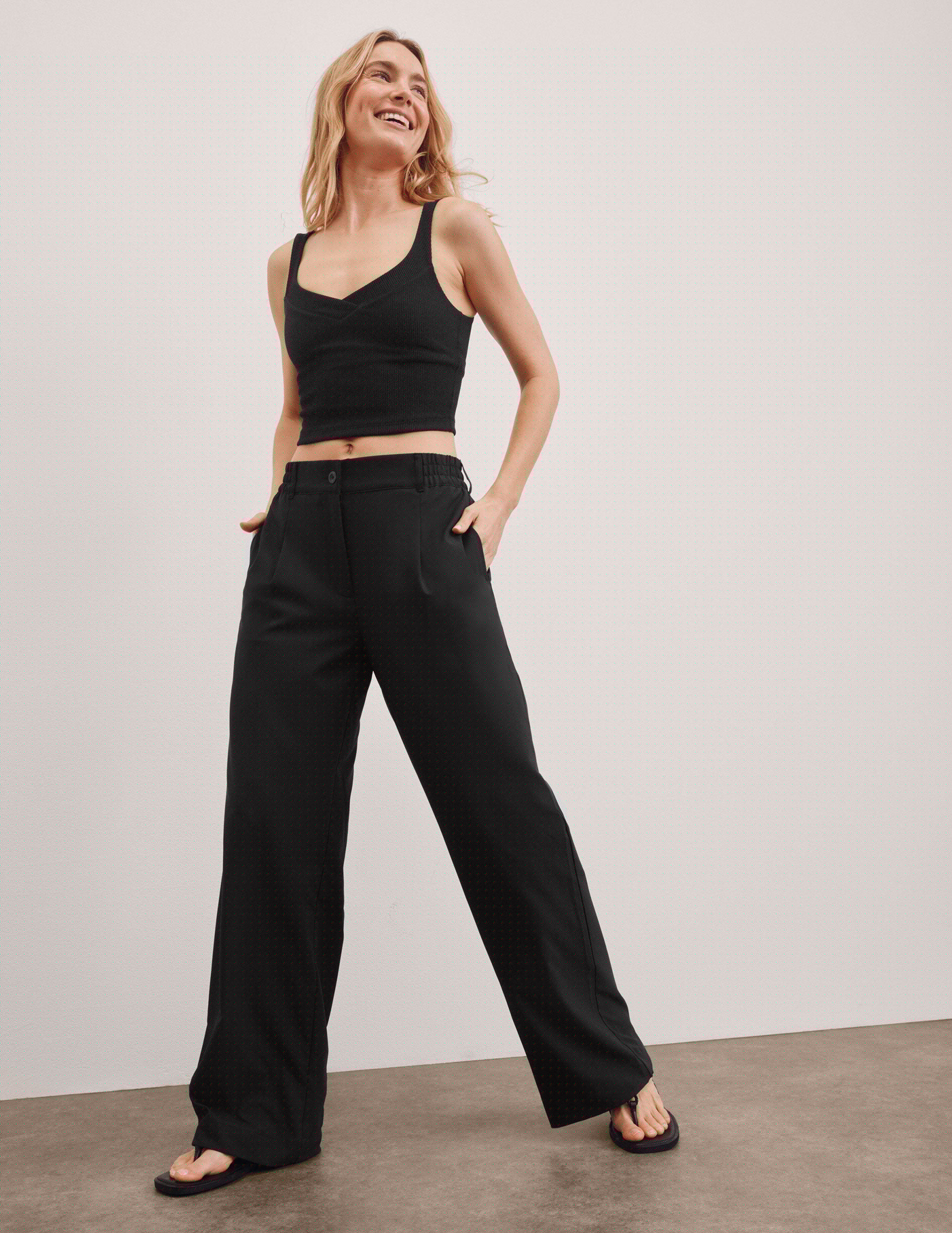 black mid rise jetstretch woven pants with cargo style pockets.