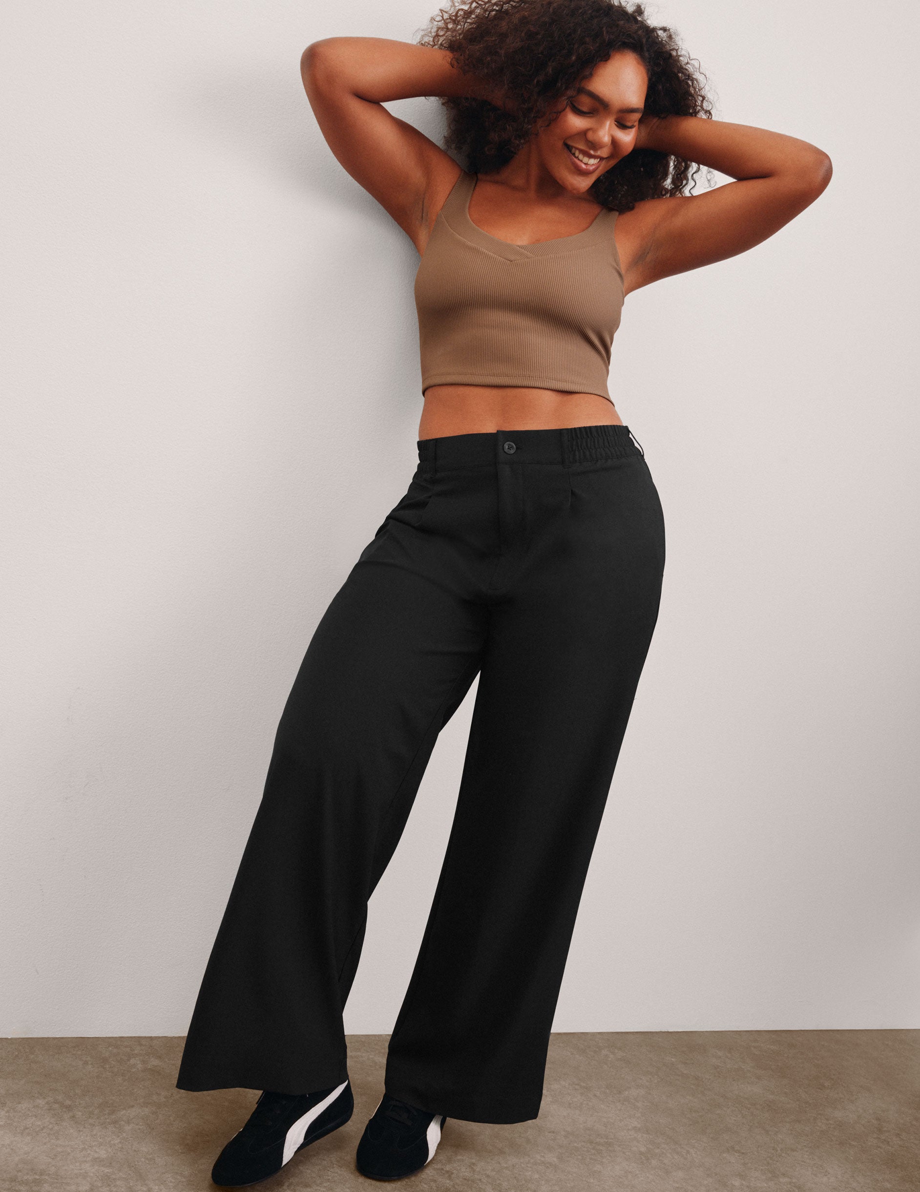 black mid rise jetstretch woven pants with cargo style pockets.