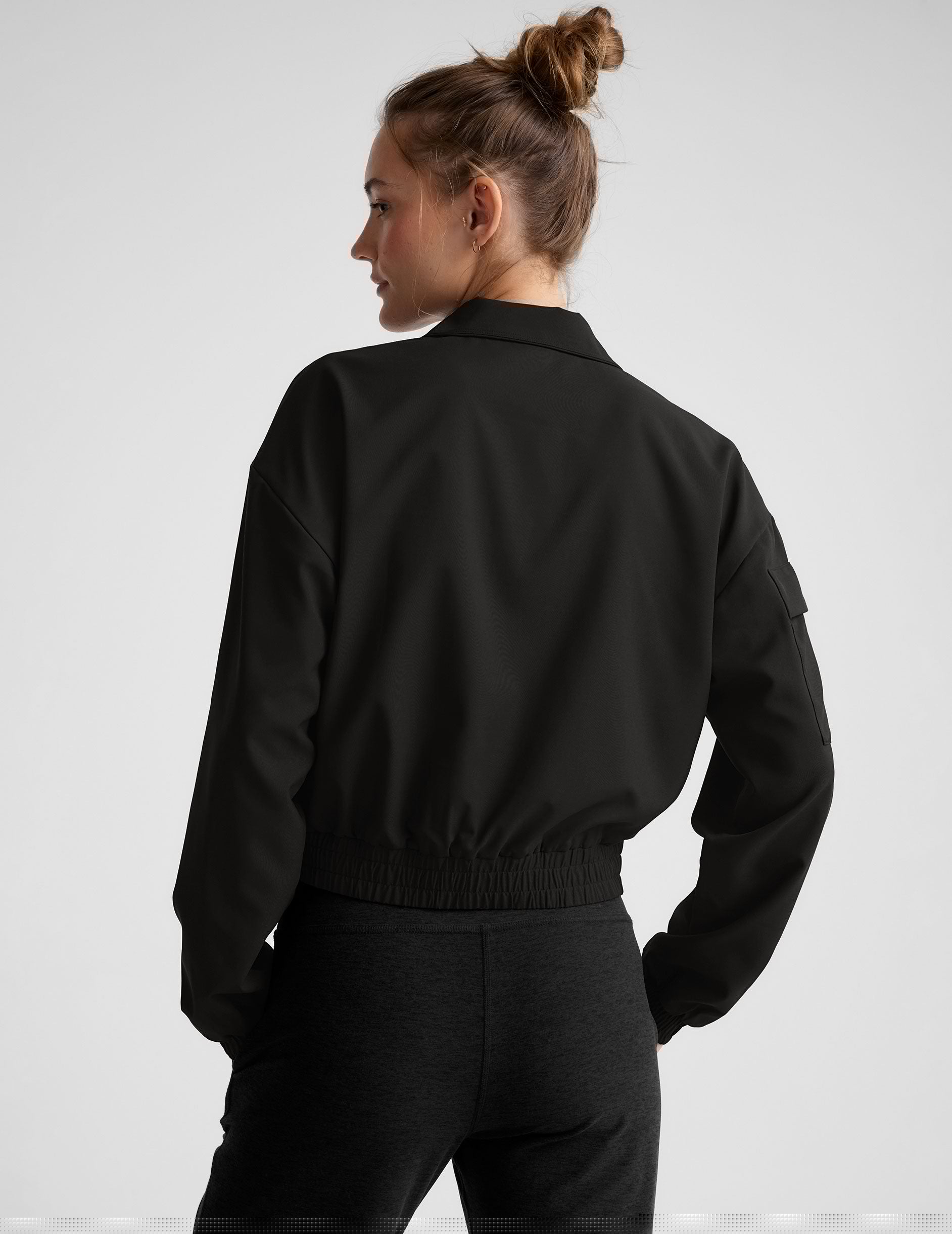 black zip-up jetstretch woven jacket with a collar.