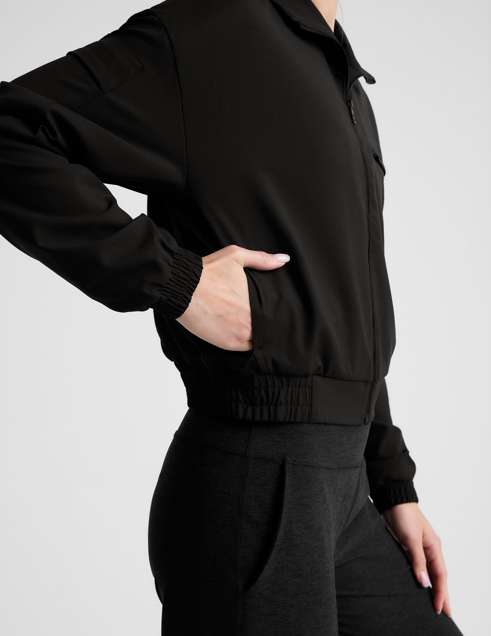 black zip-up jetstretch woven jacket with a collar.