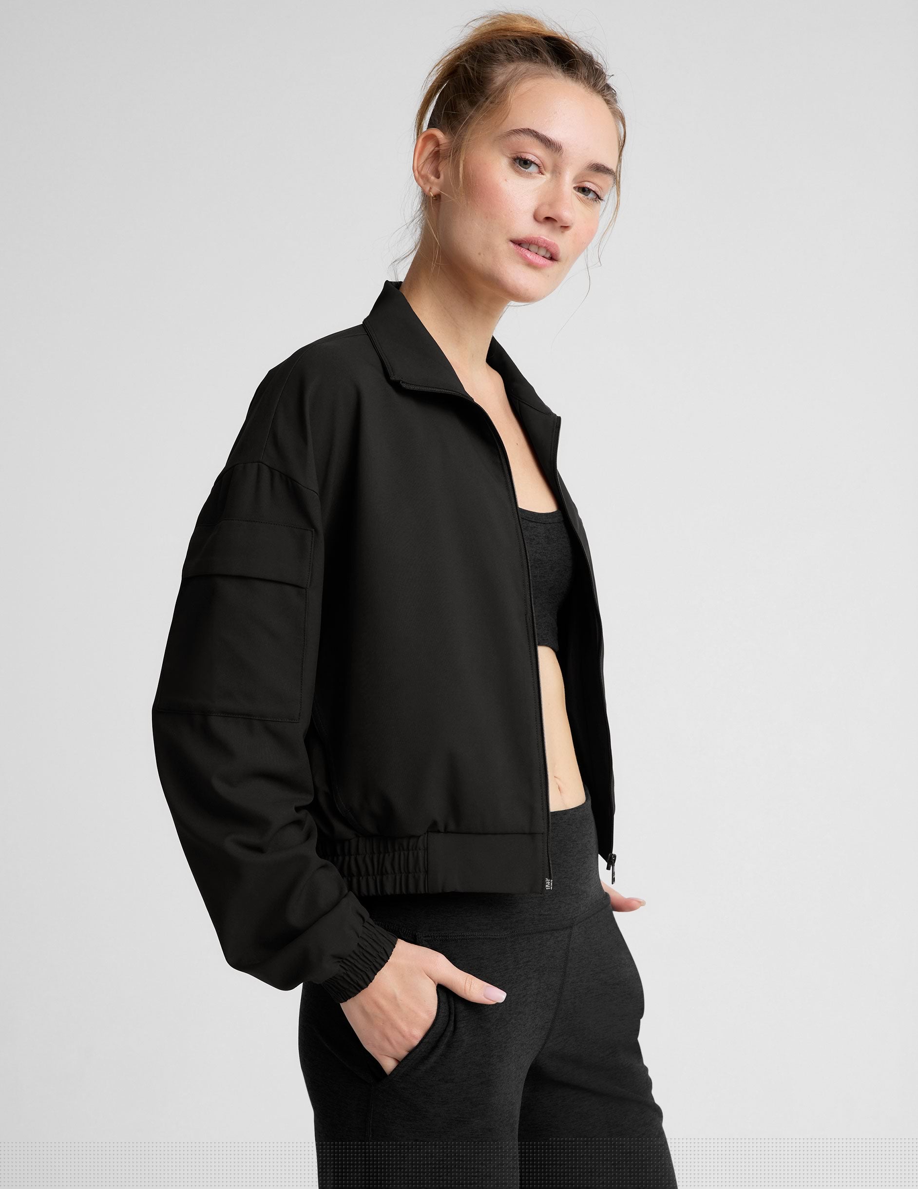 black zip-up jetstretch woven jacket with a collar.