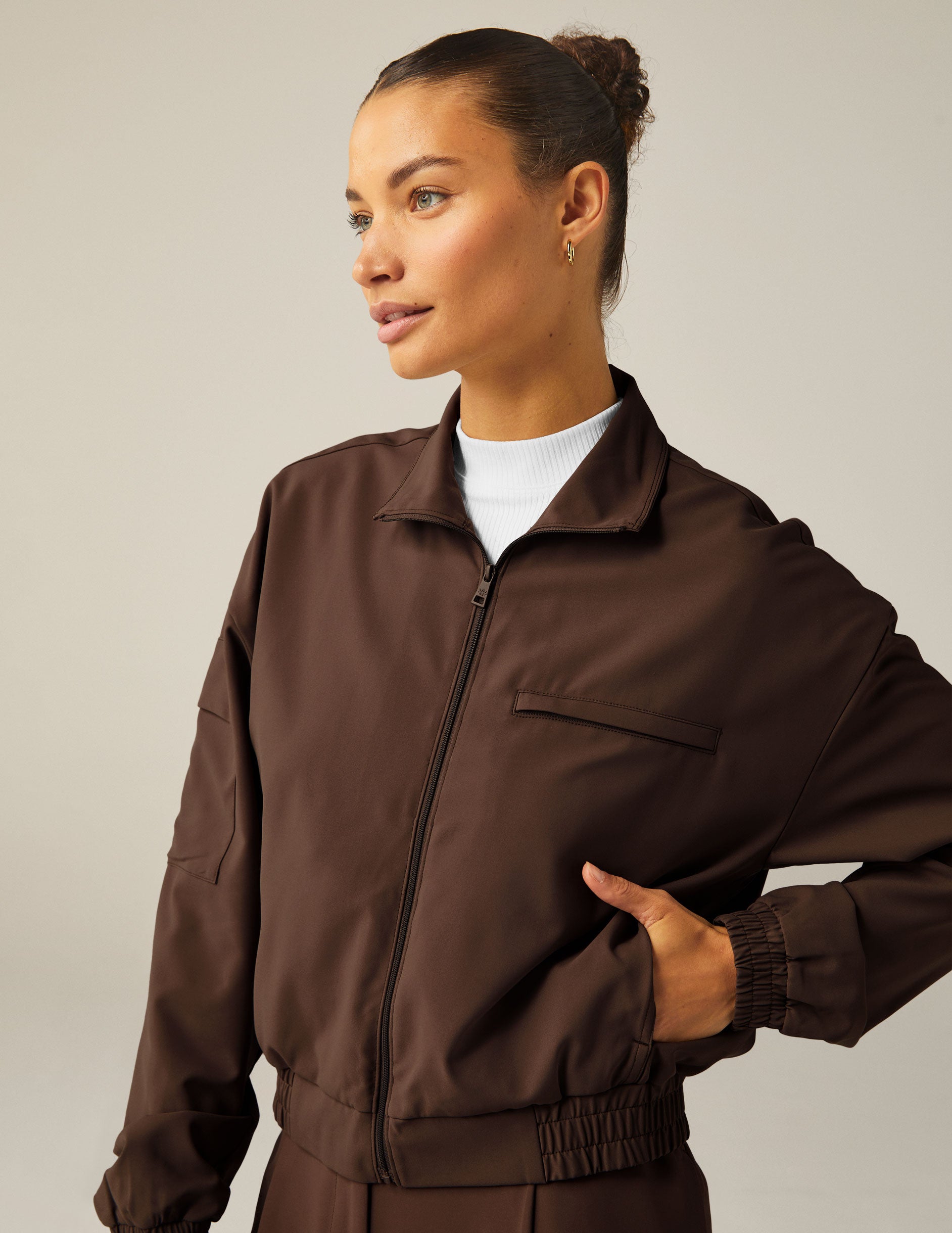 brown collared zip-up jacket with side pockets.