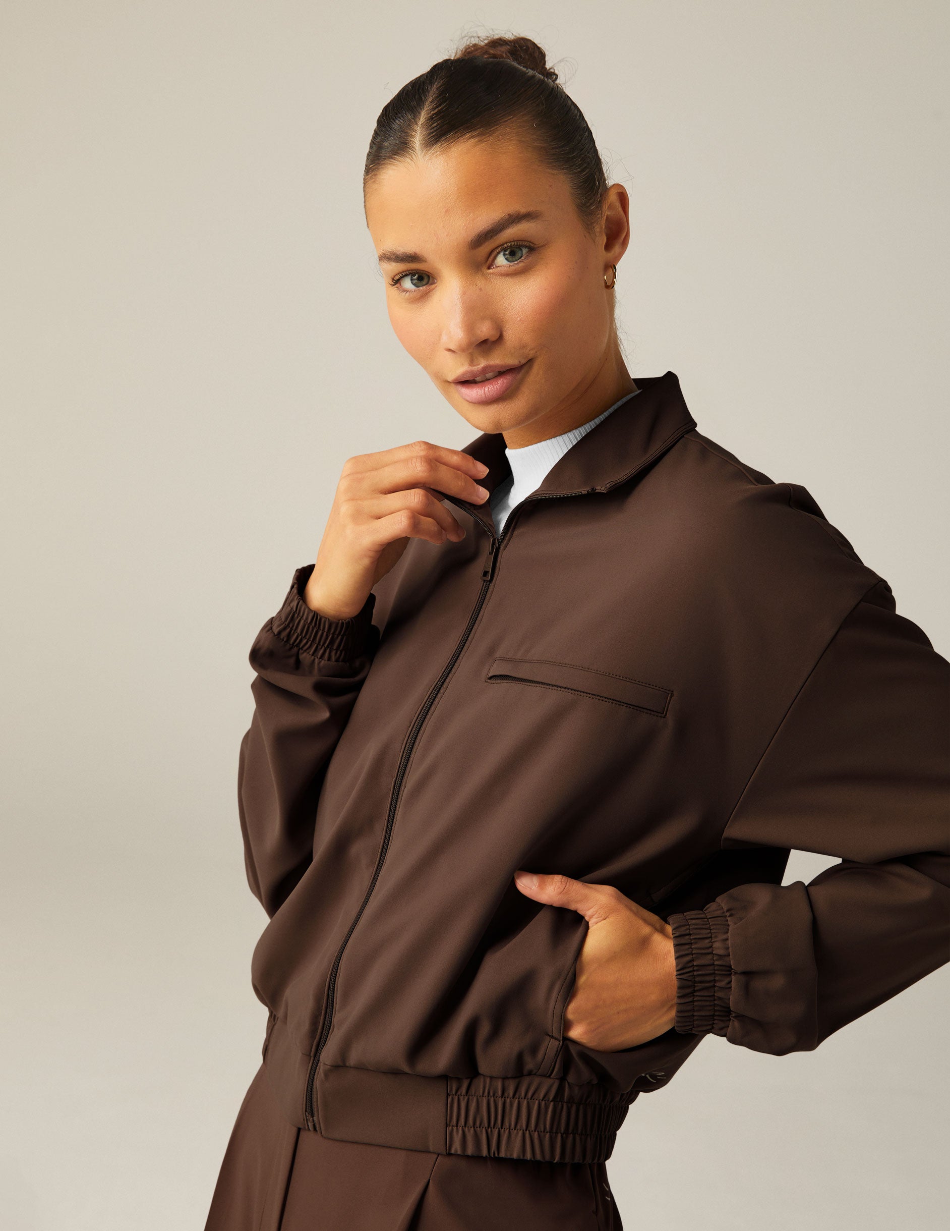 brown collared zip-up jacket with side pockets.