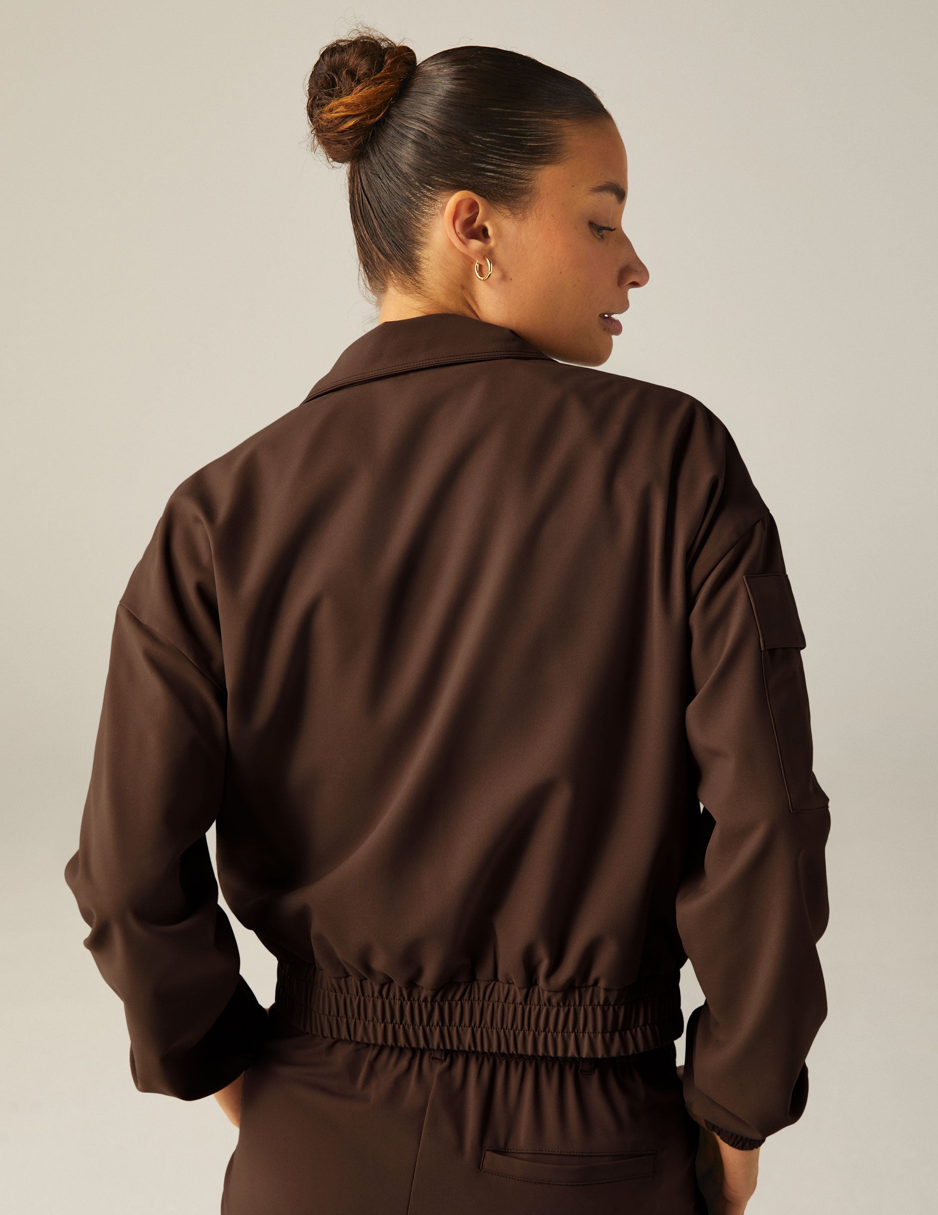 brown collared zip-up jacket with side pockets.