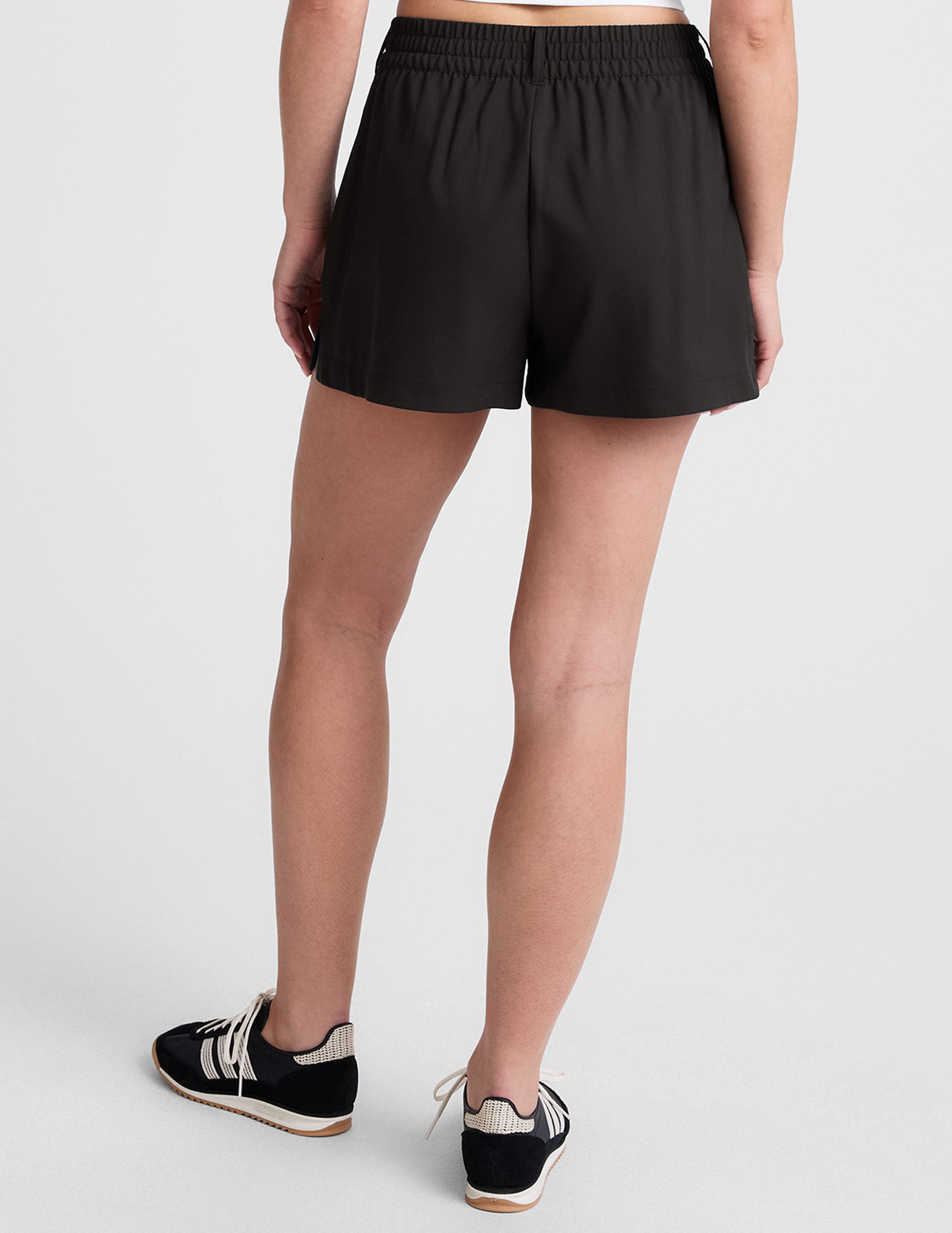 black 4" inseam shorts with an elastic waistband with belt loops and side seam pockets.