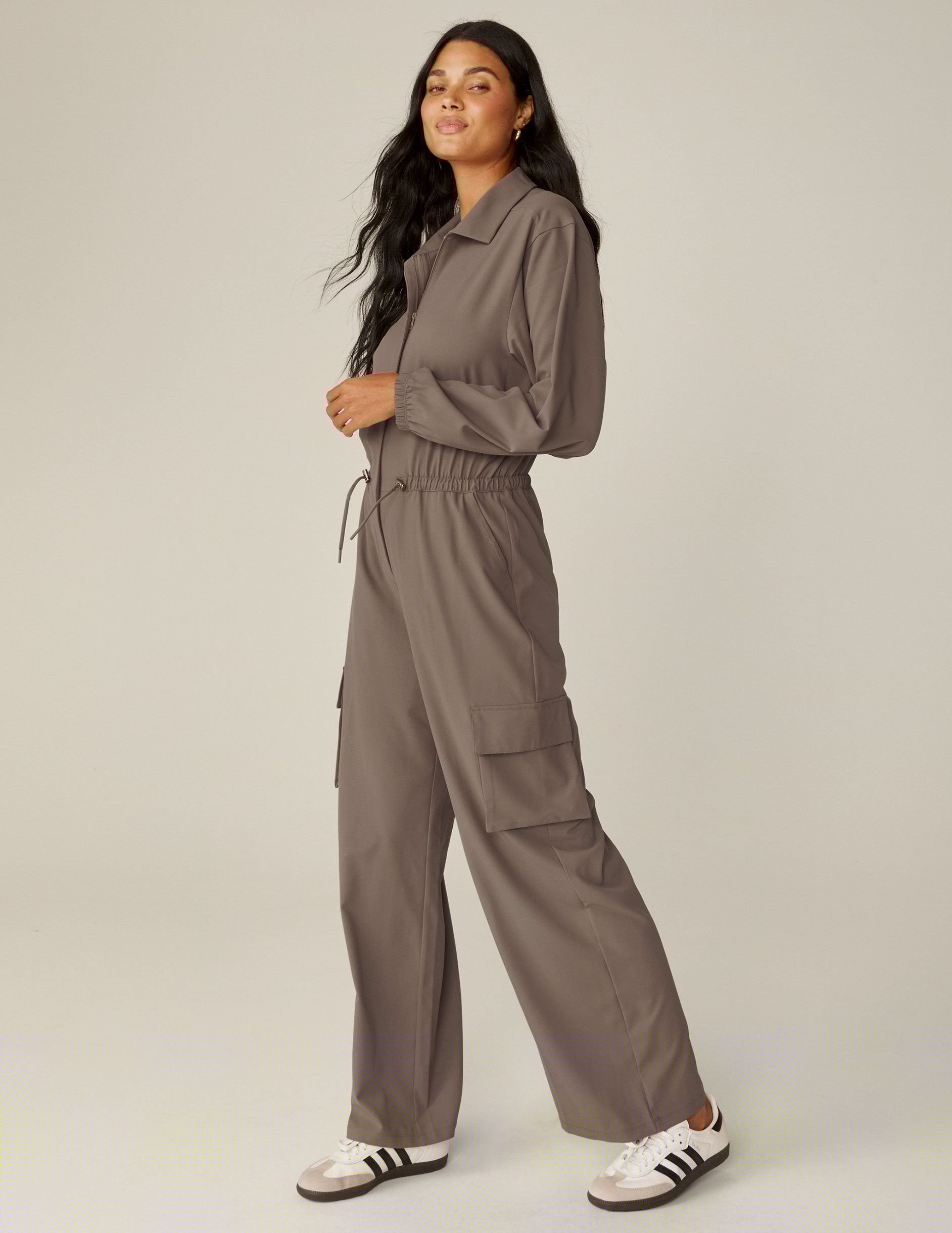 brown long sleeve cargo style jumpsuit with pockets.