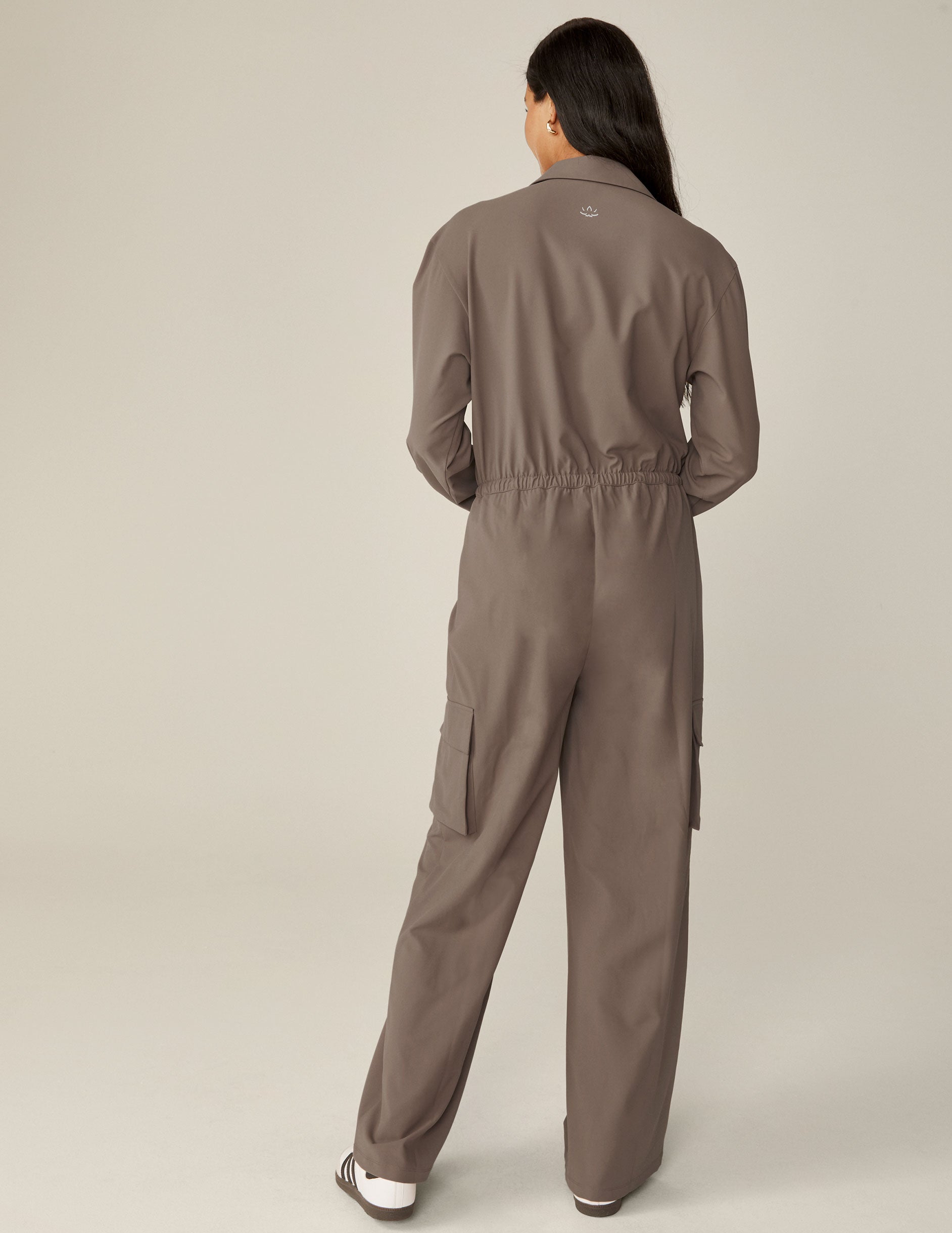 brown long sleeve cargo style jumpsuit with pockets.