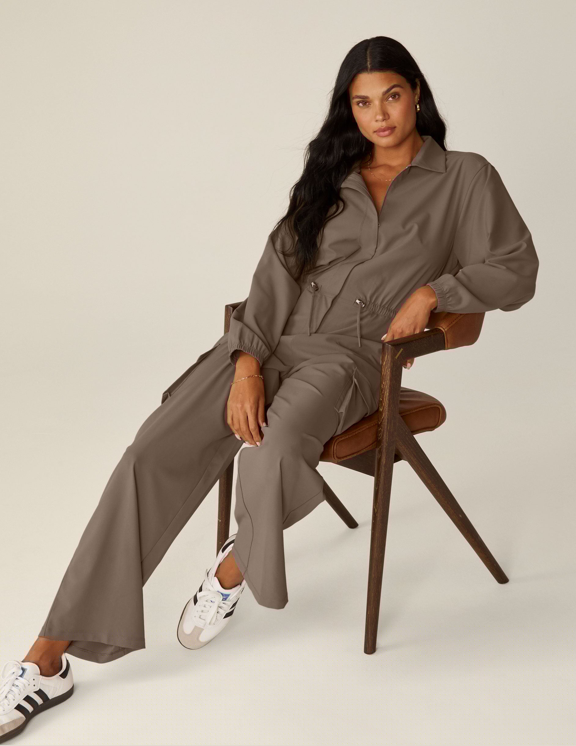 brown long sleeve cargo style jumpsuit with pockets.