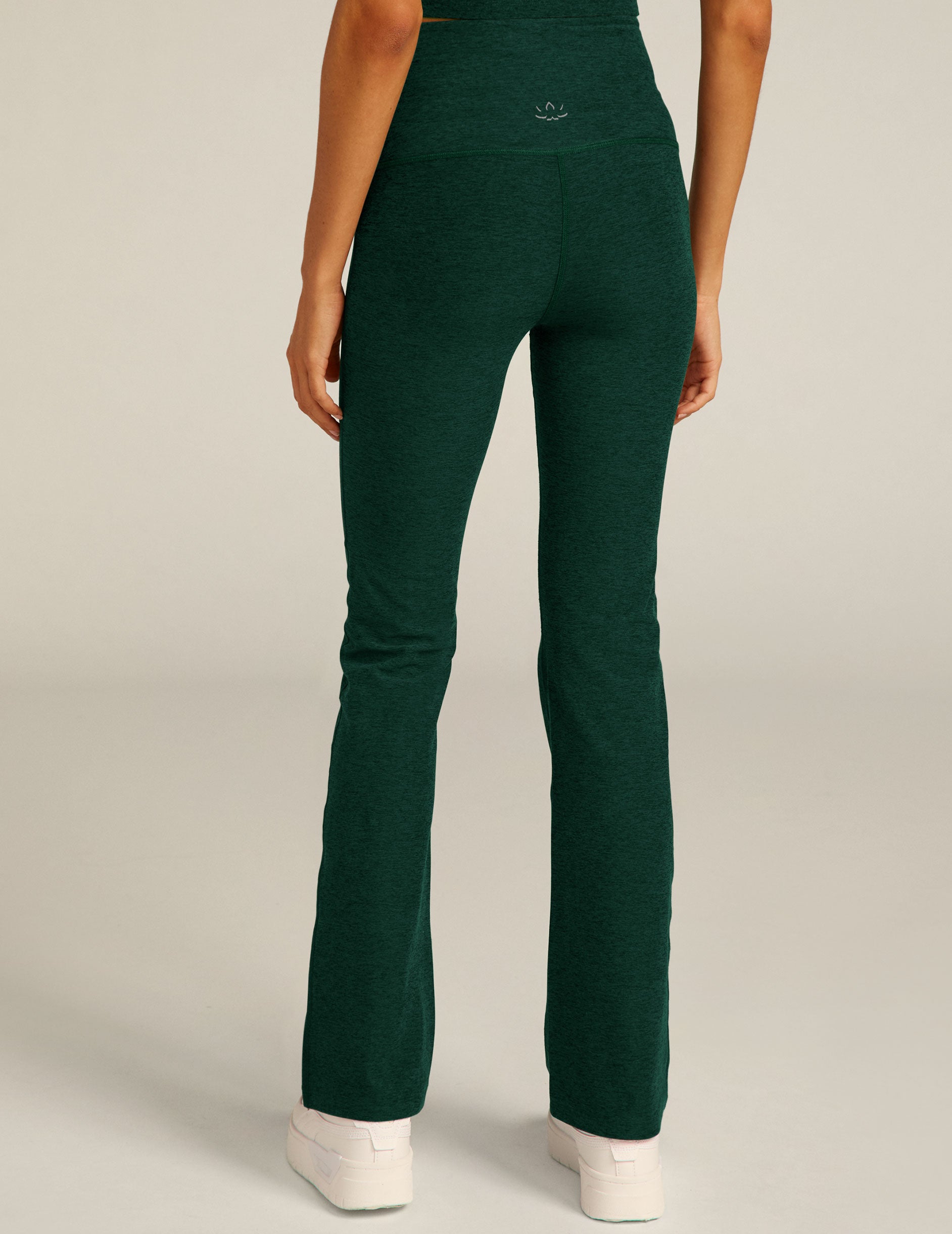 green high-waisted bootcut style pants.