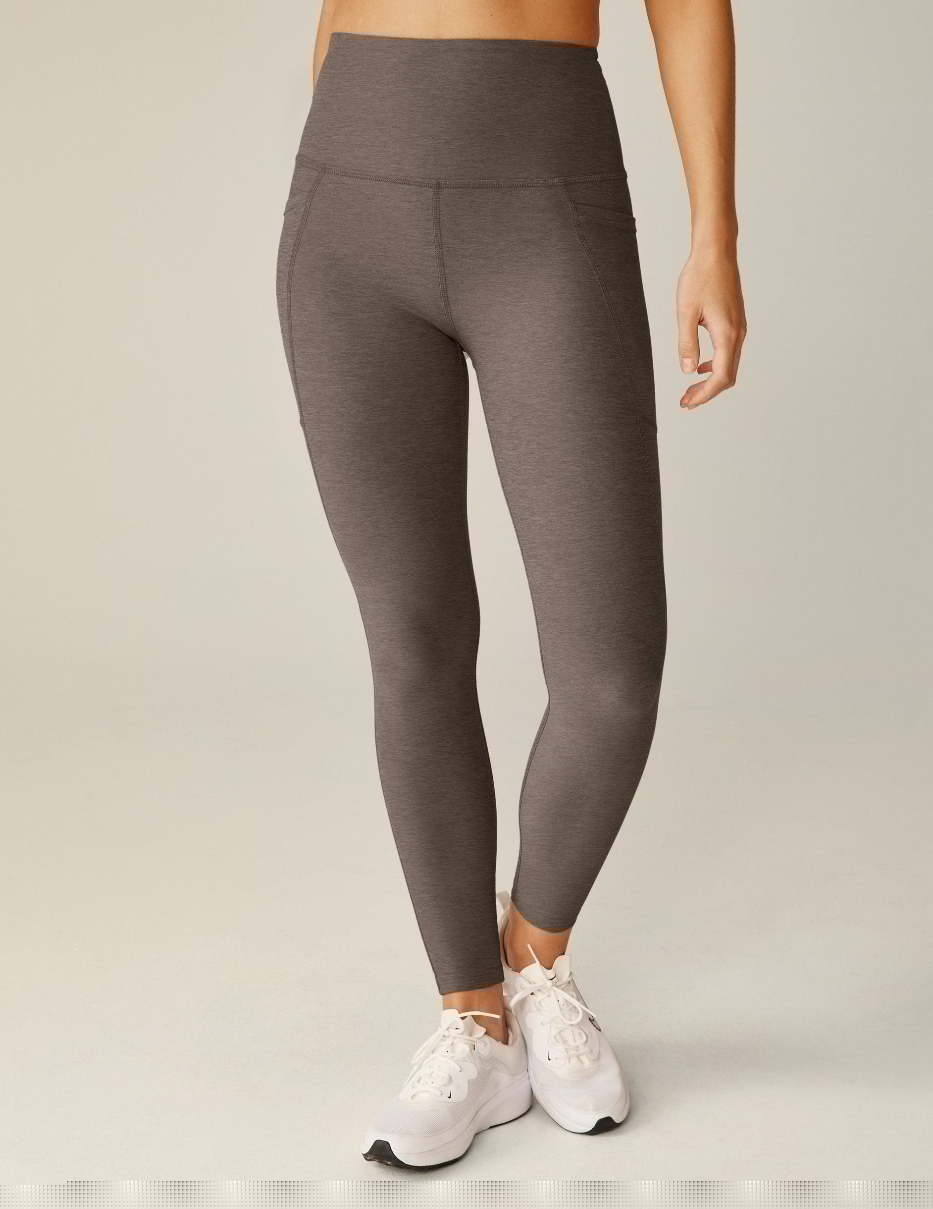 brown high-waisted midi leggings with pockets.