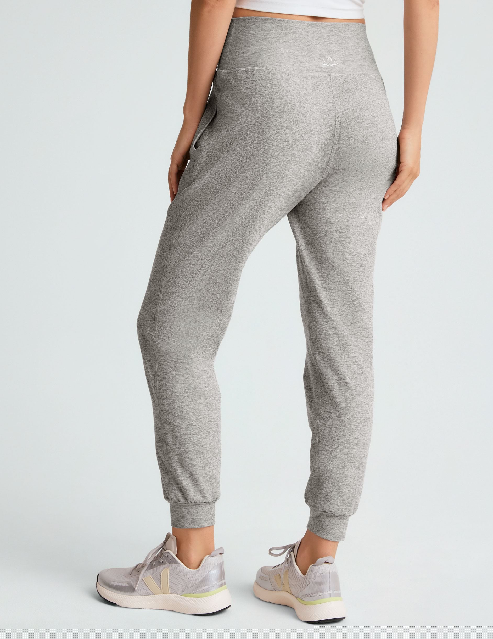 grey high-waisted midi length jogger pants with pockets.