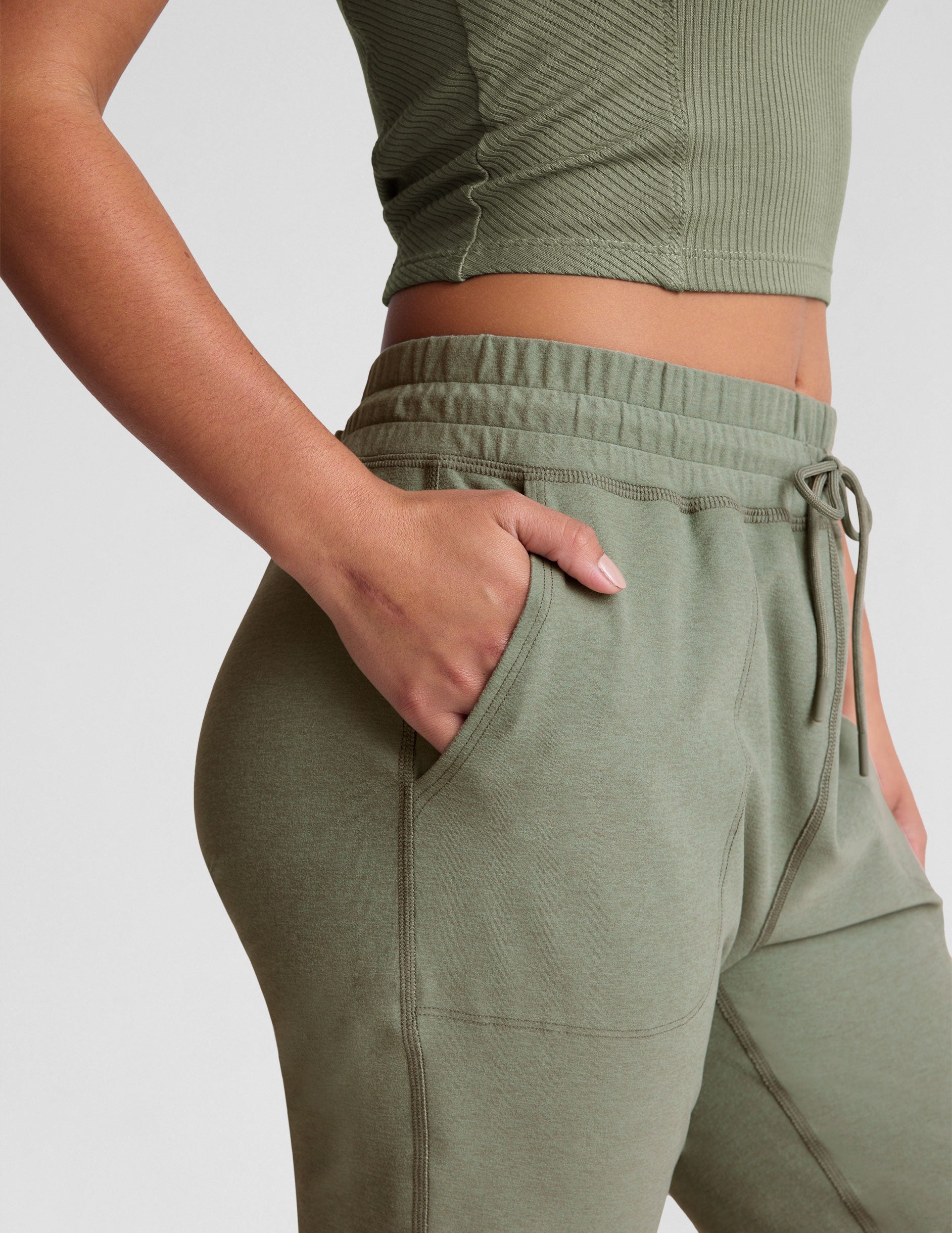 green midi length joggers with a drawstring in waistband and pockets.