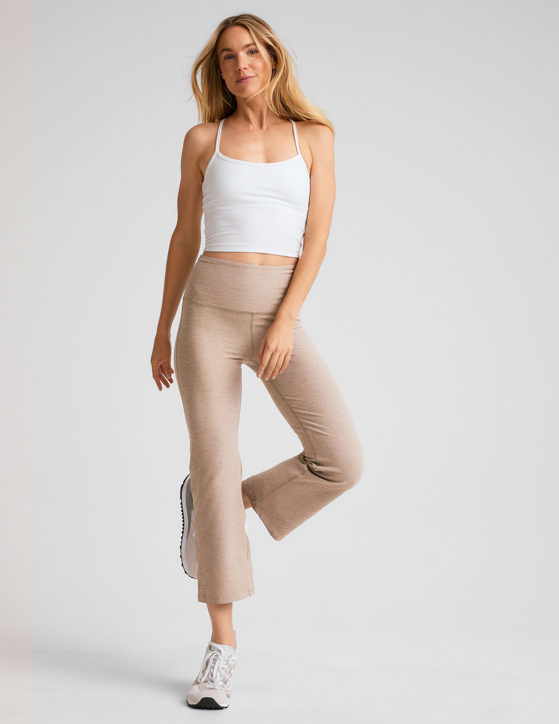 light brown high-waisted cropped flare pants.